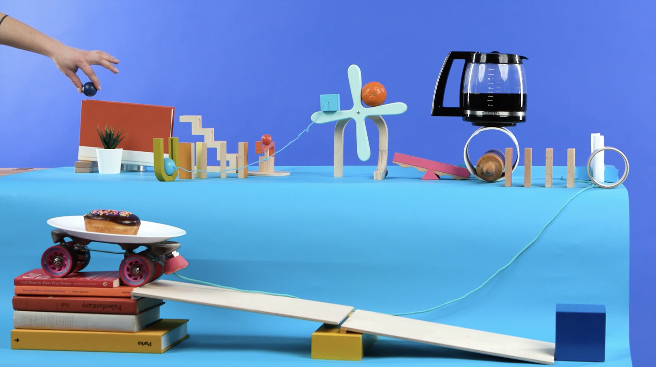Rube Goldberg machine created with a Momentix Toys kit that ultimately serves coffee and a donut
