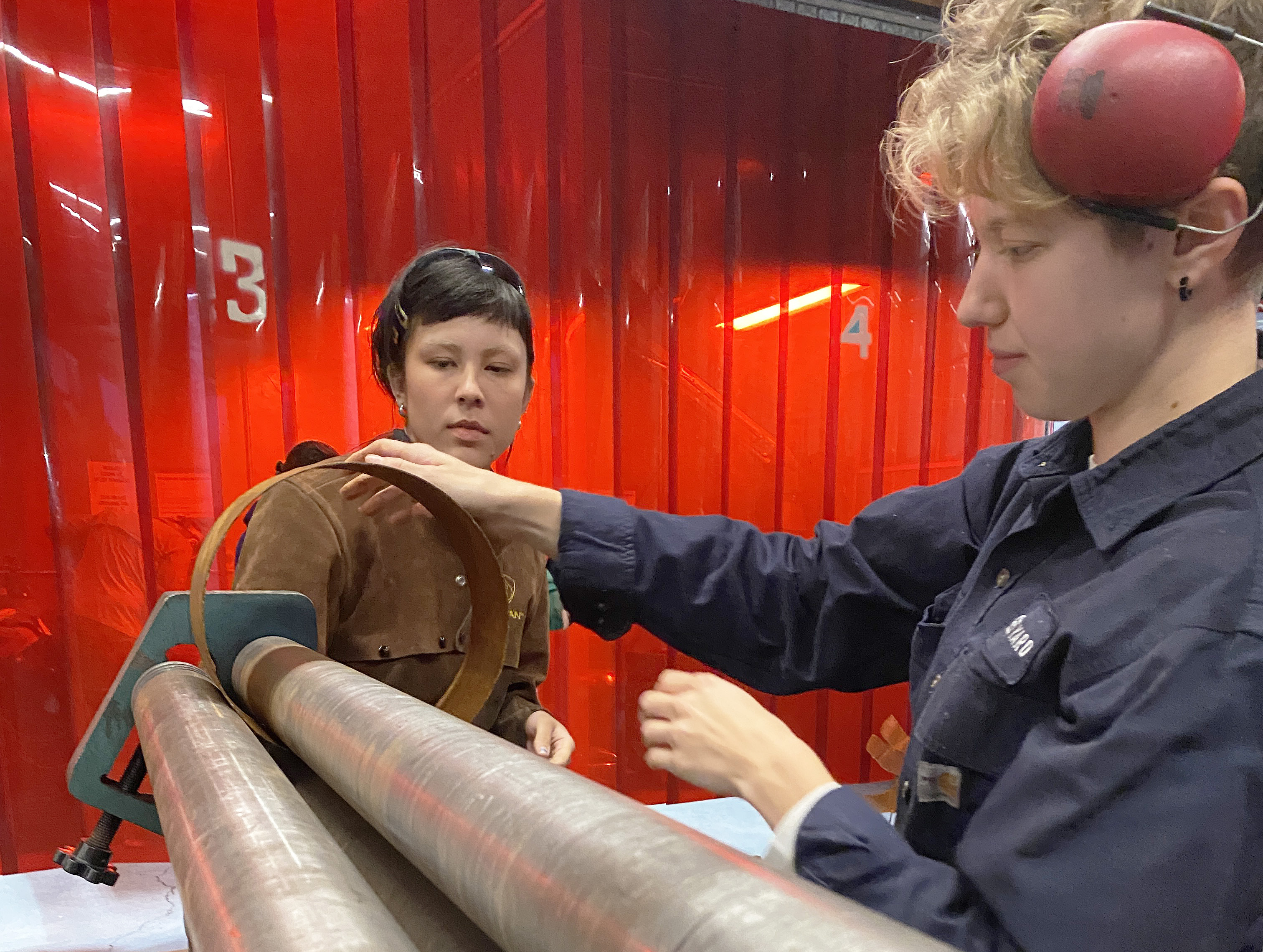 Madeleine Young works with a student at the Steel Yard