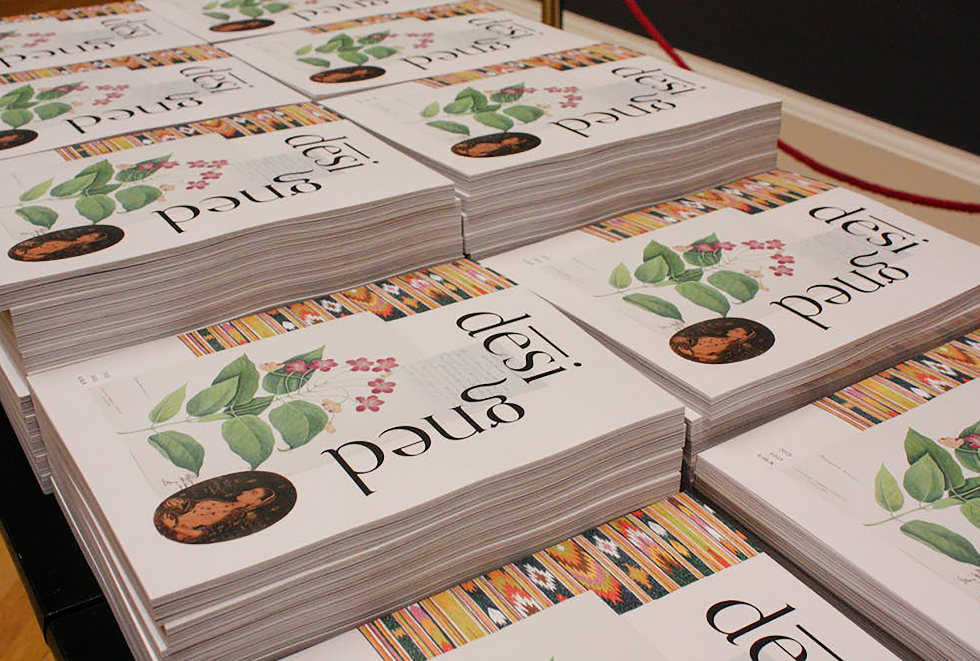 stacks of desi-gned magazines laid out on a table