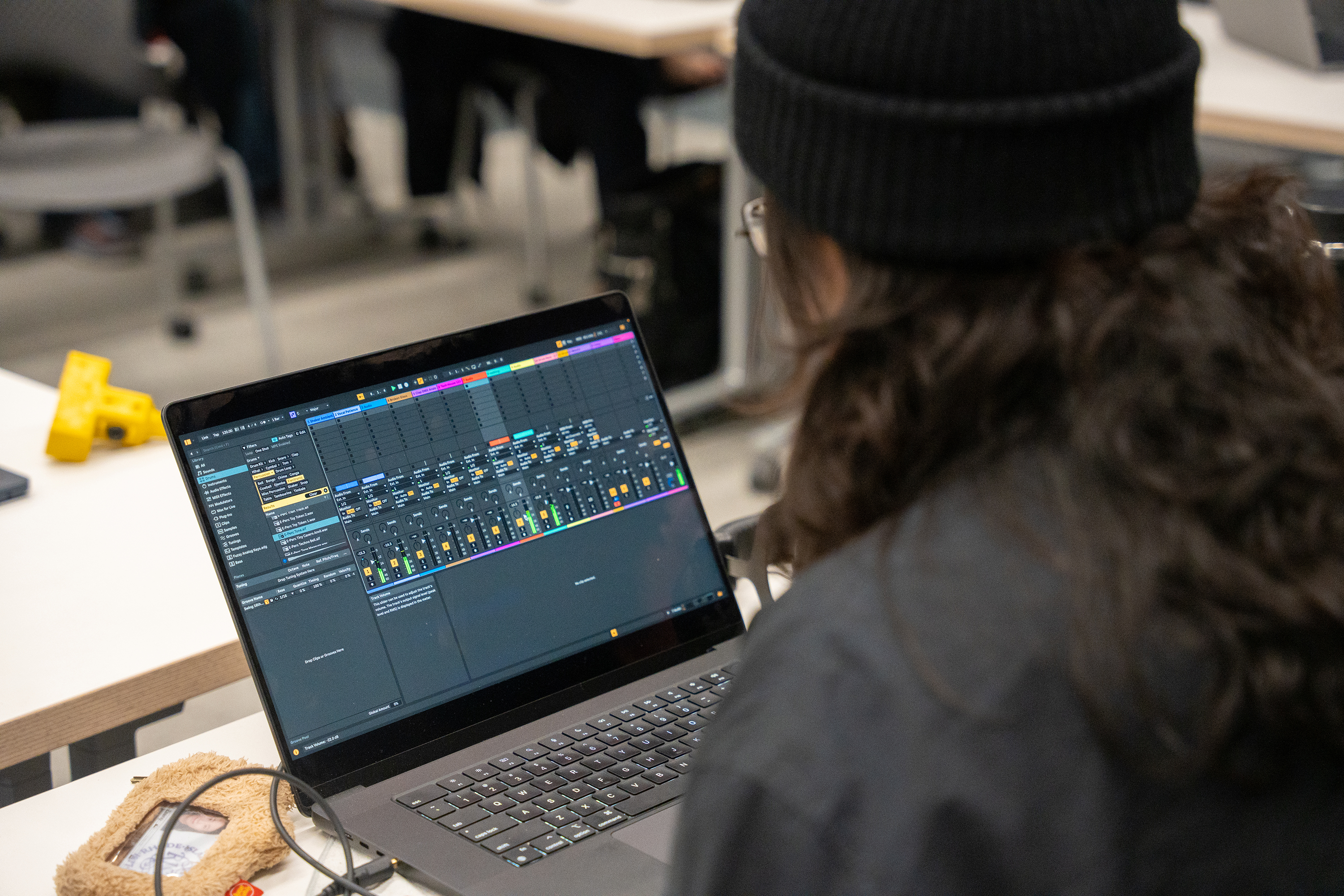 student adjusting audio channels on her laptop