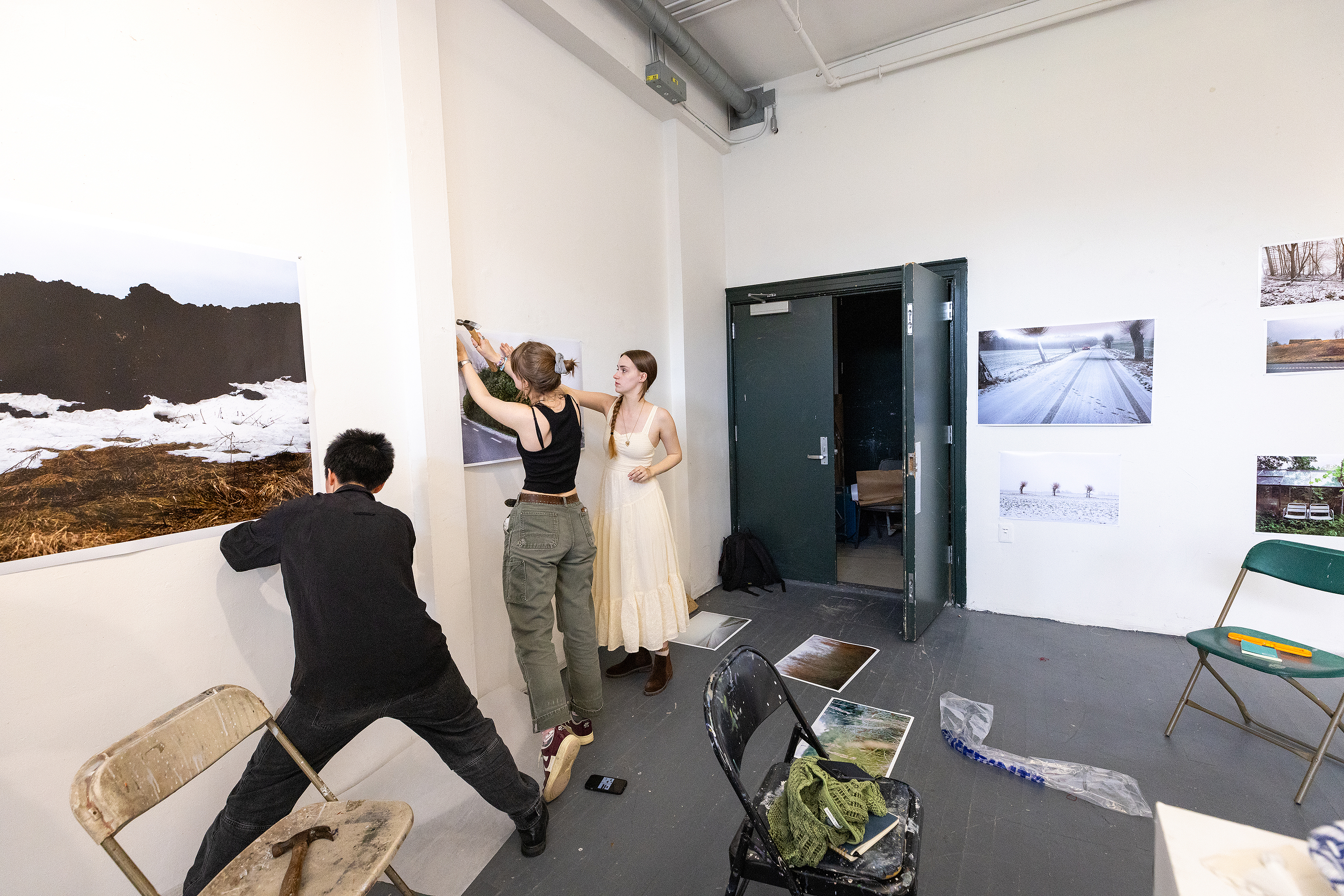 students post large-format photographs in preparation for a crit