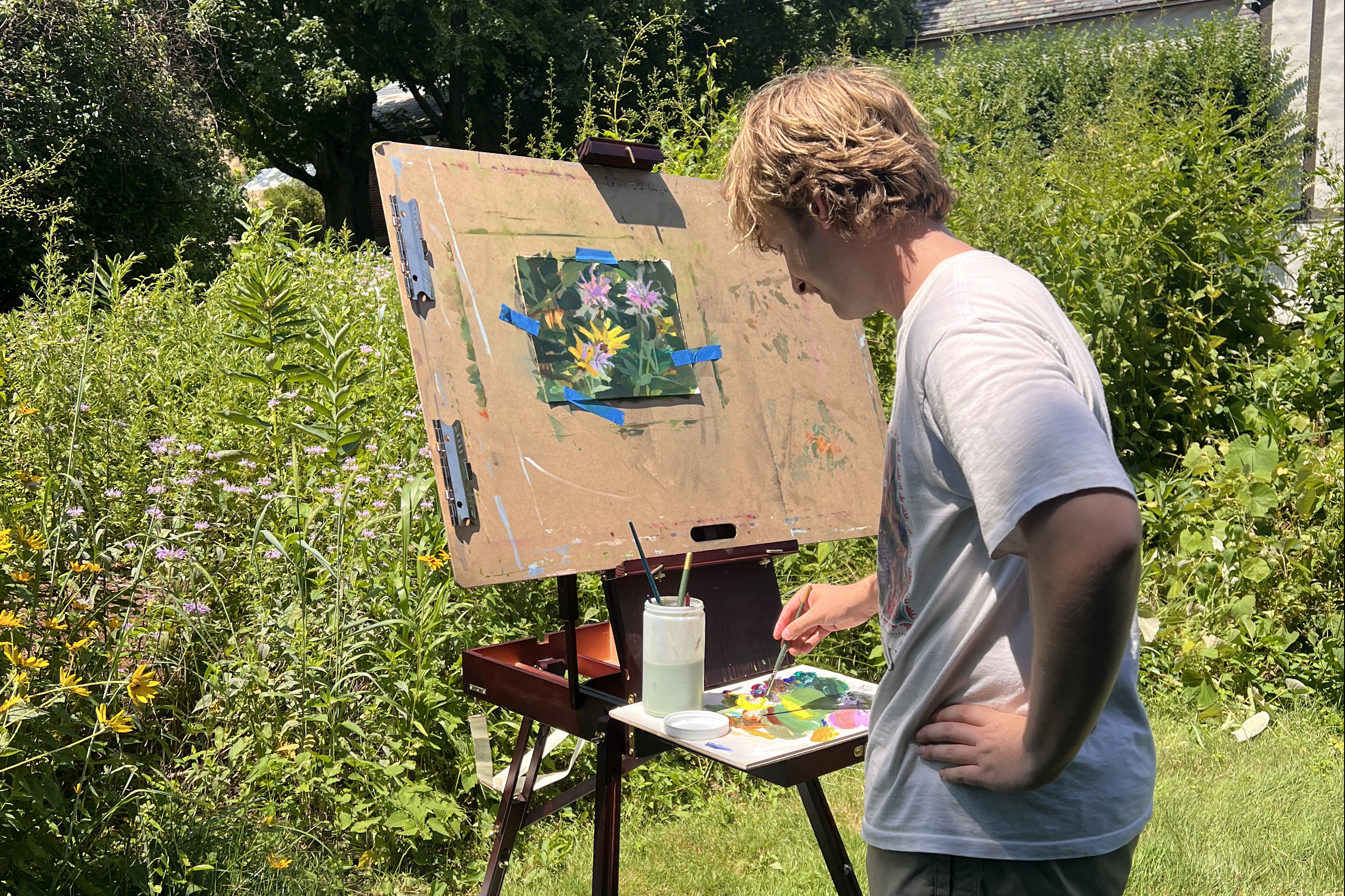 Phillip Walker painting flowers in the sunshine