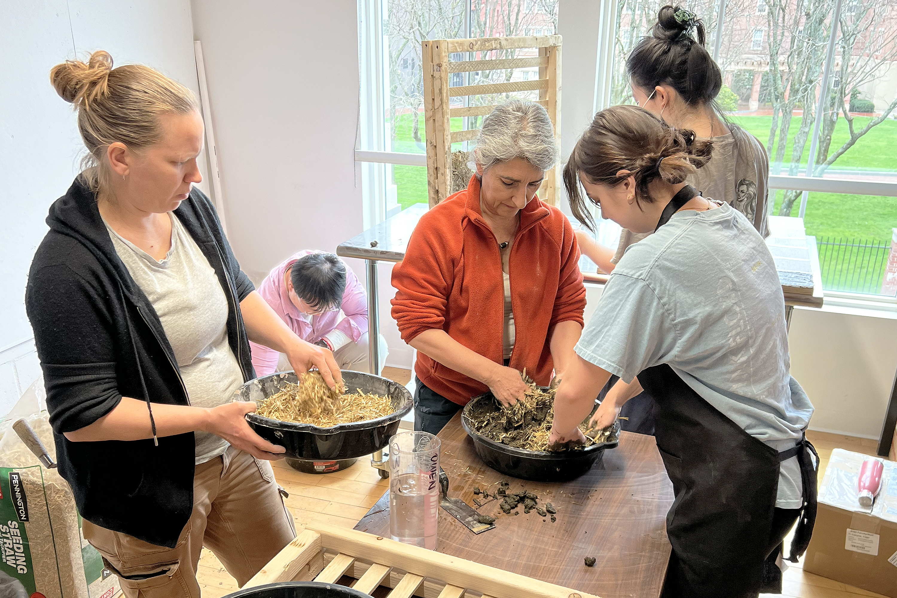 Lara David, Achenza, students mix soil, water and straw