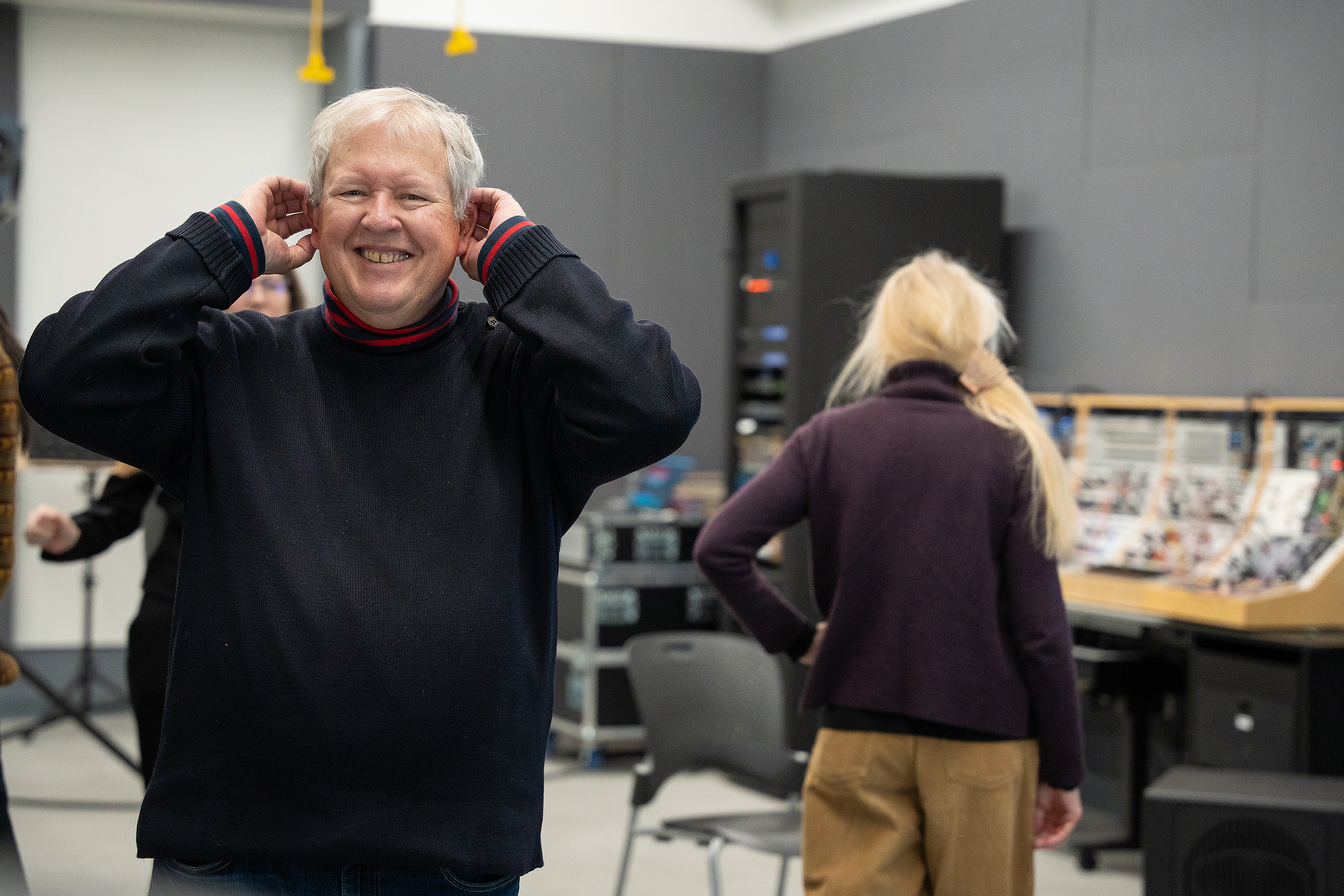 Chris Frantz cups his ears to better hear the spatial audio in RISD's SRST