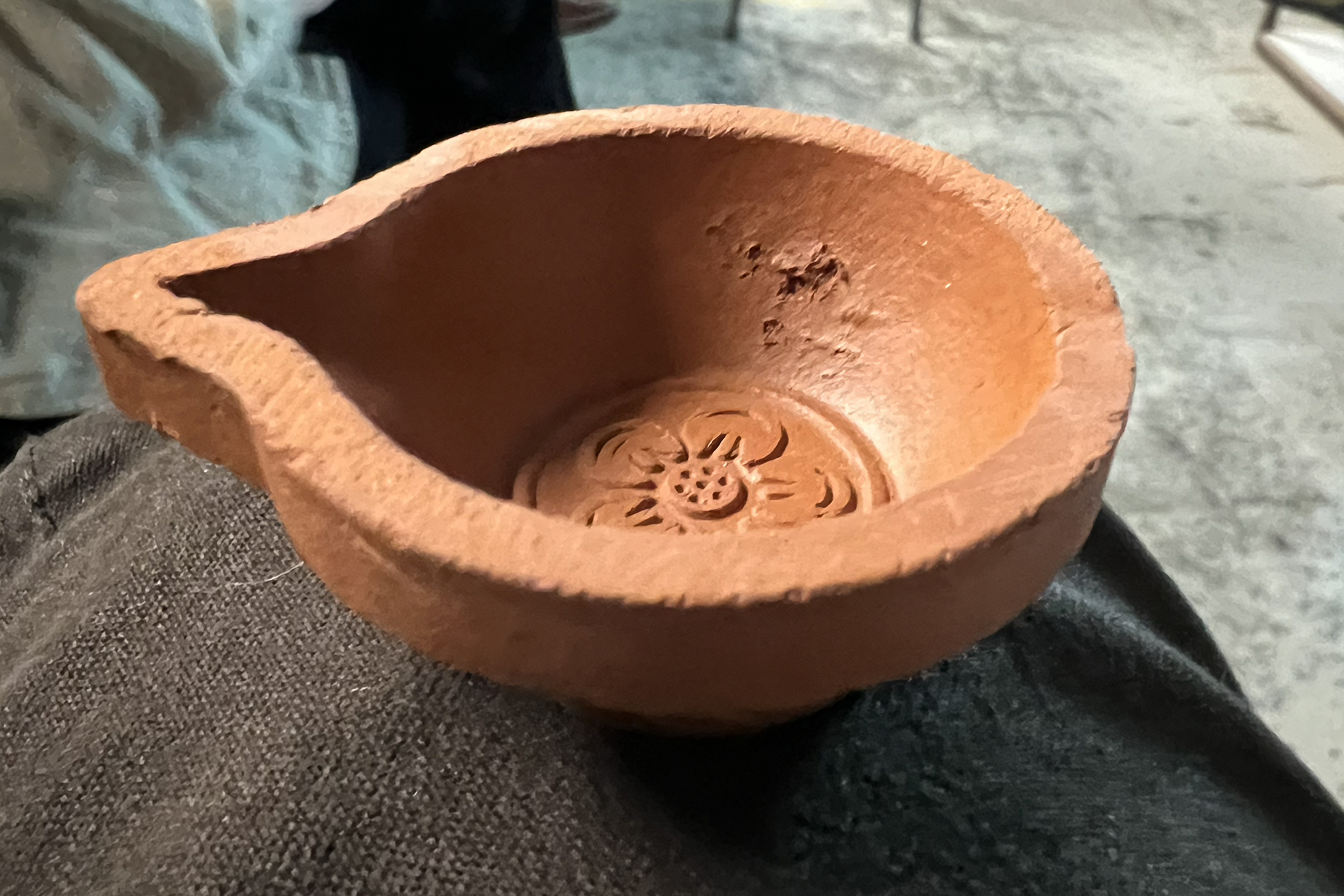 a tiny clay lamp from Singapore