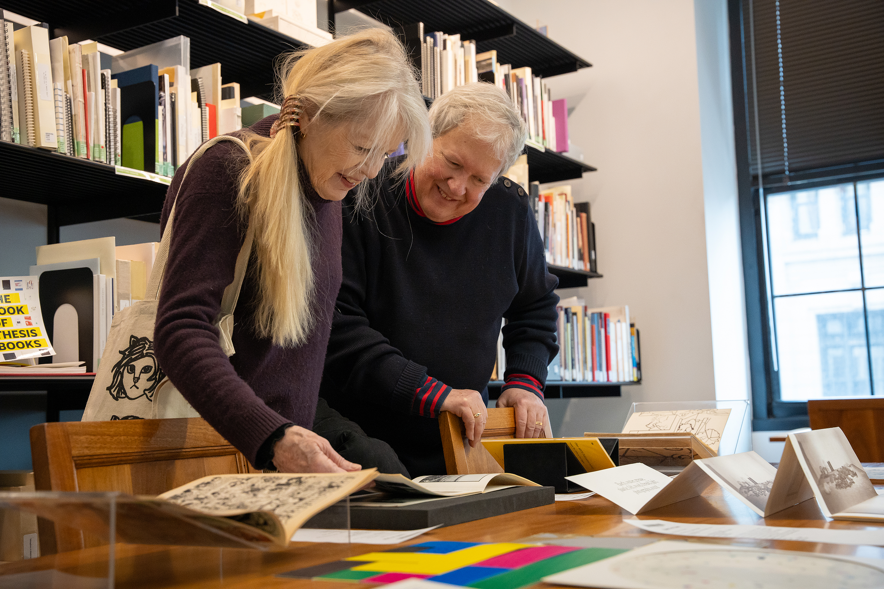 Weymouth and Frantz look at old publications in the RISD Archives
