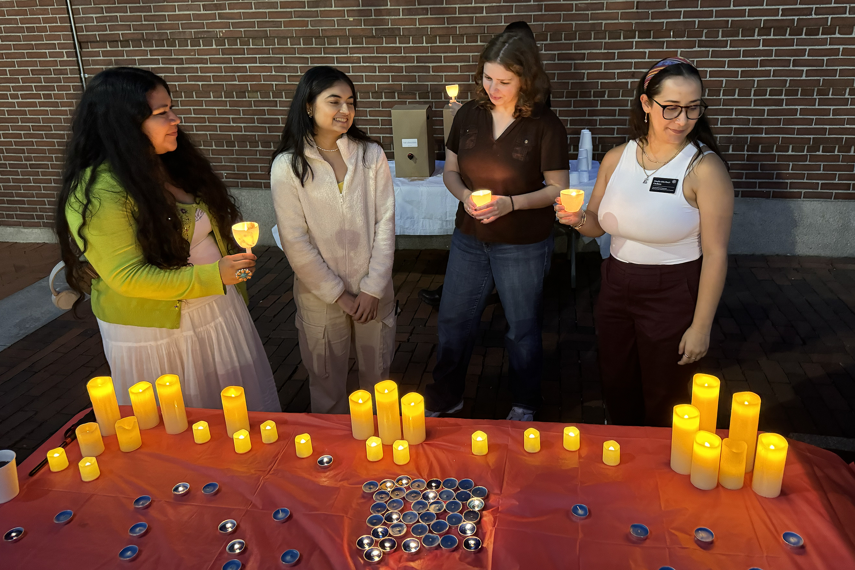 students at a candlelight vigil in Market Square
