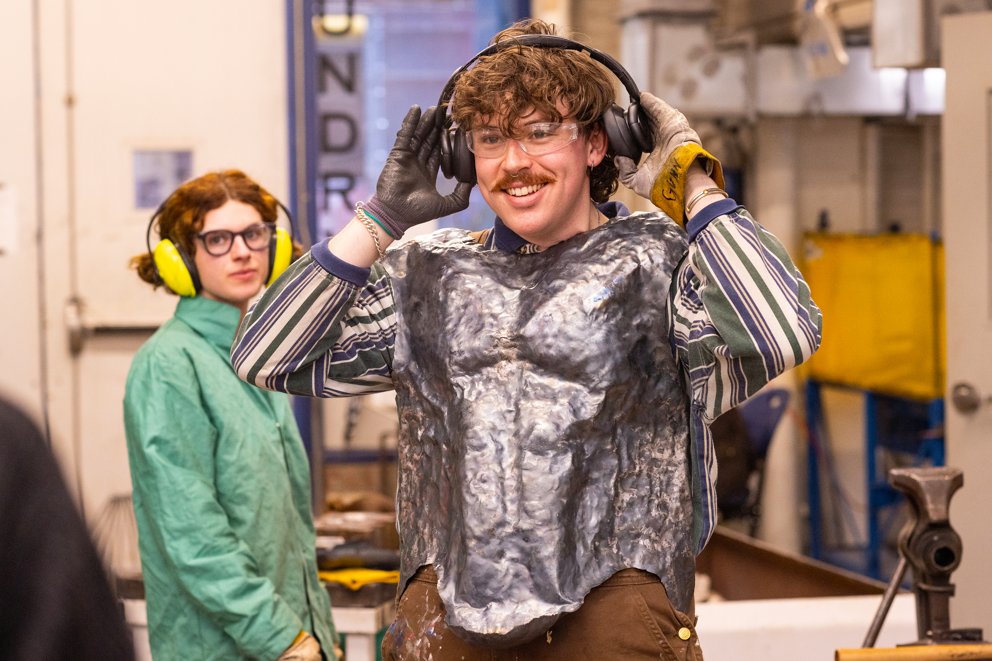 senior Michael Gunn tries on the metal chest plate he is working on