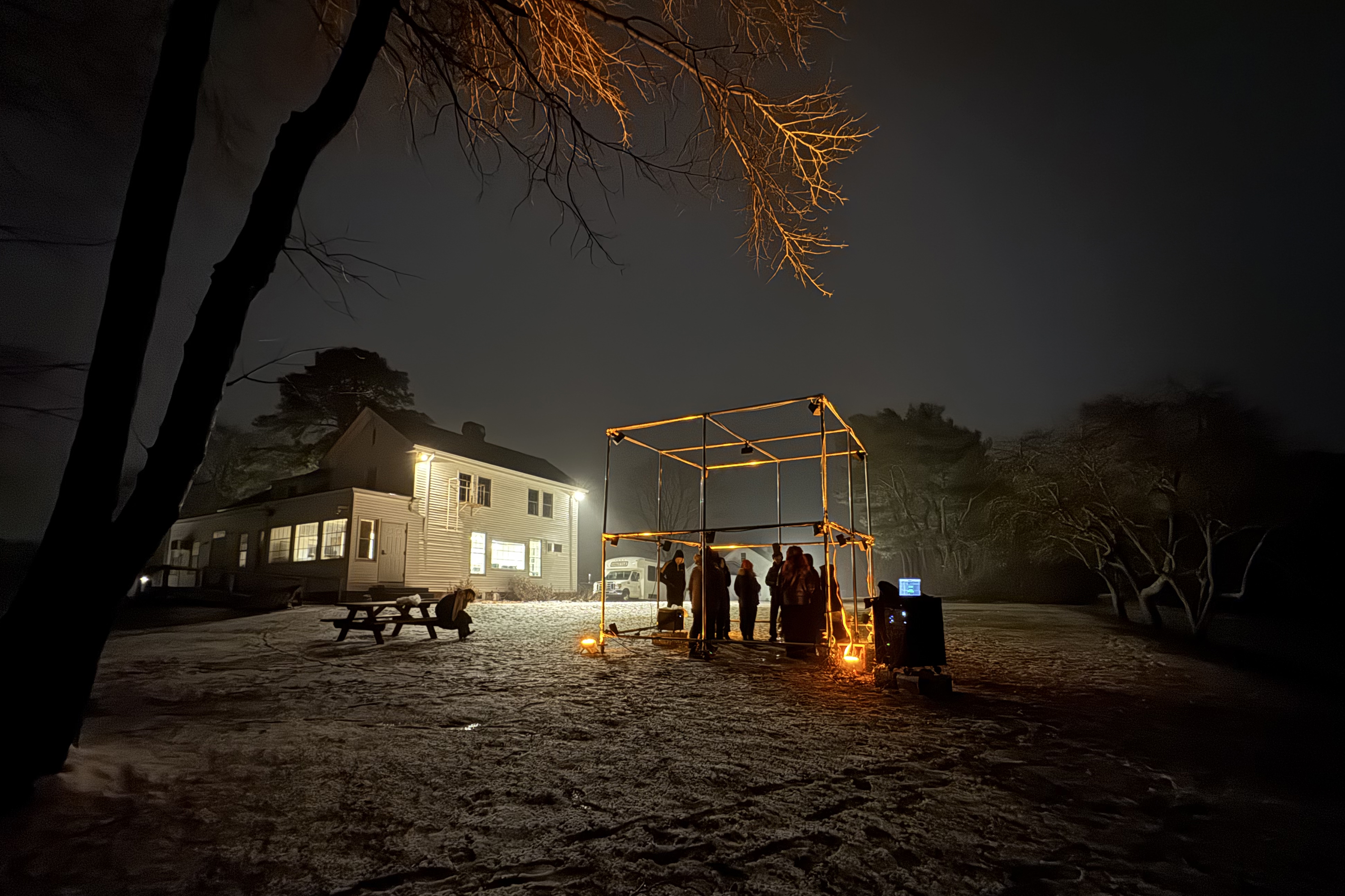 students gather in the dark for final crits