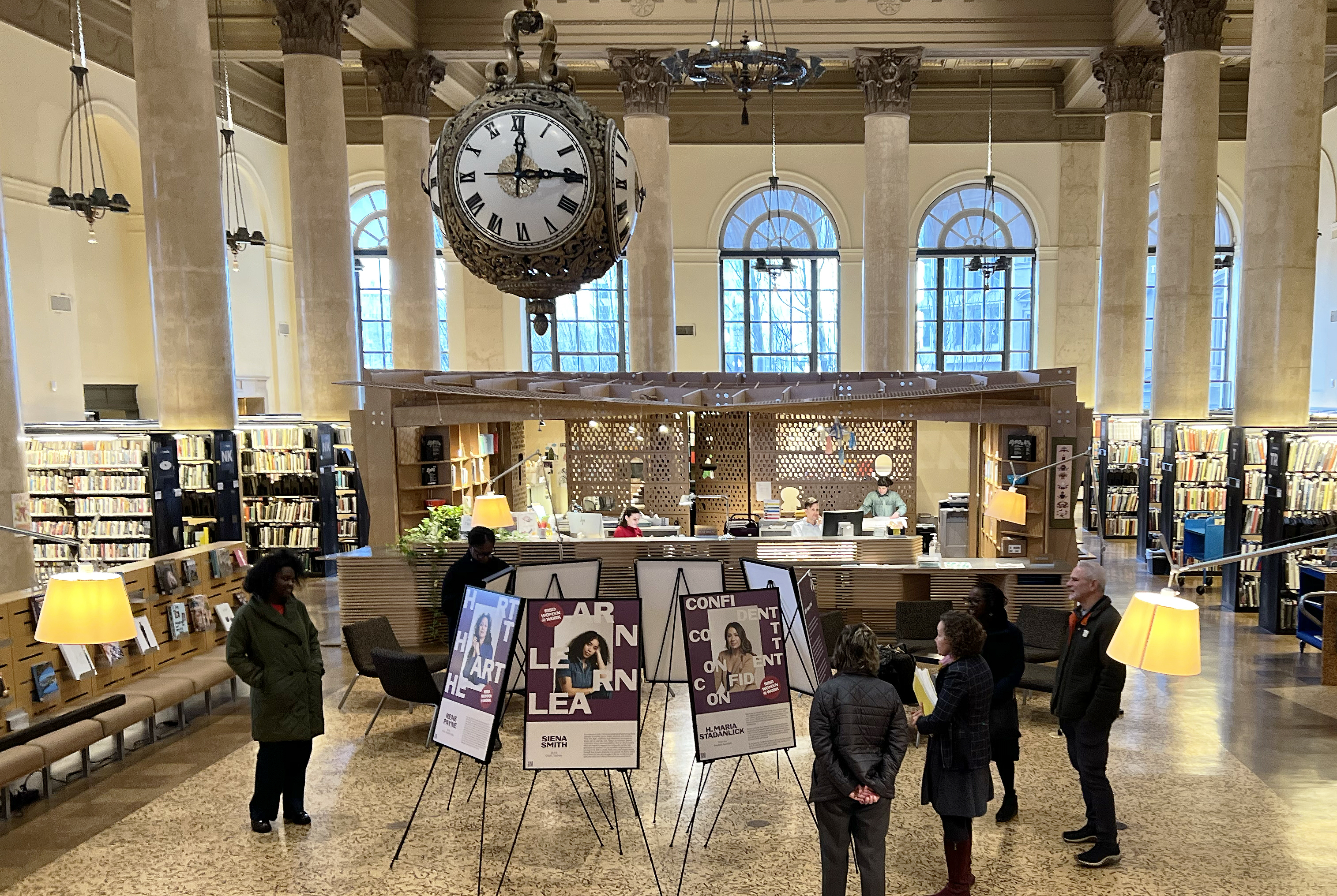 visitors view the Womxn @Work installation in the Fleet Library