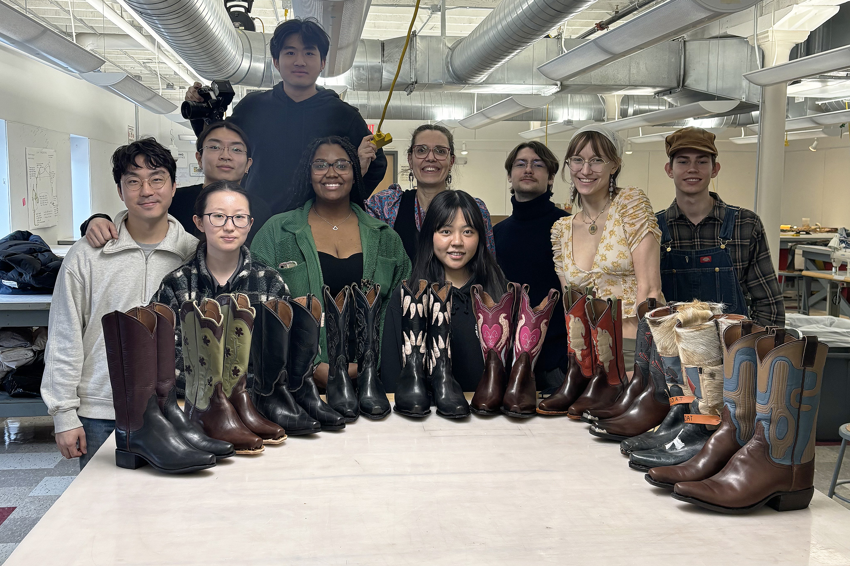 the class poses with their finished boots