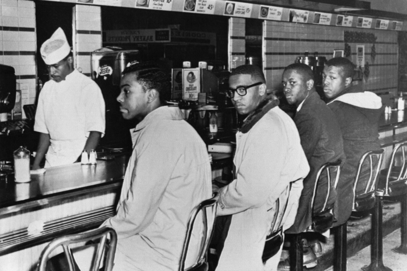 historic black-and-white photograph of Black activists conducting a sit-in