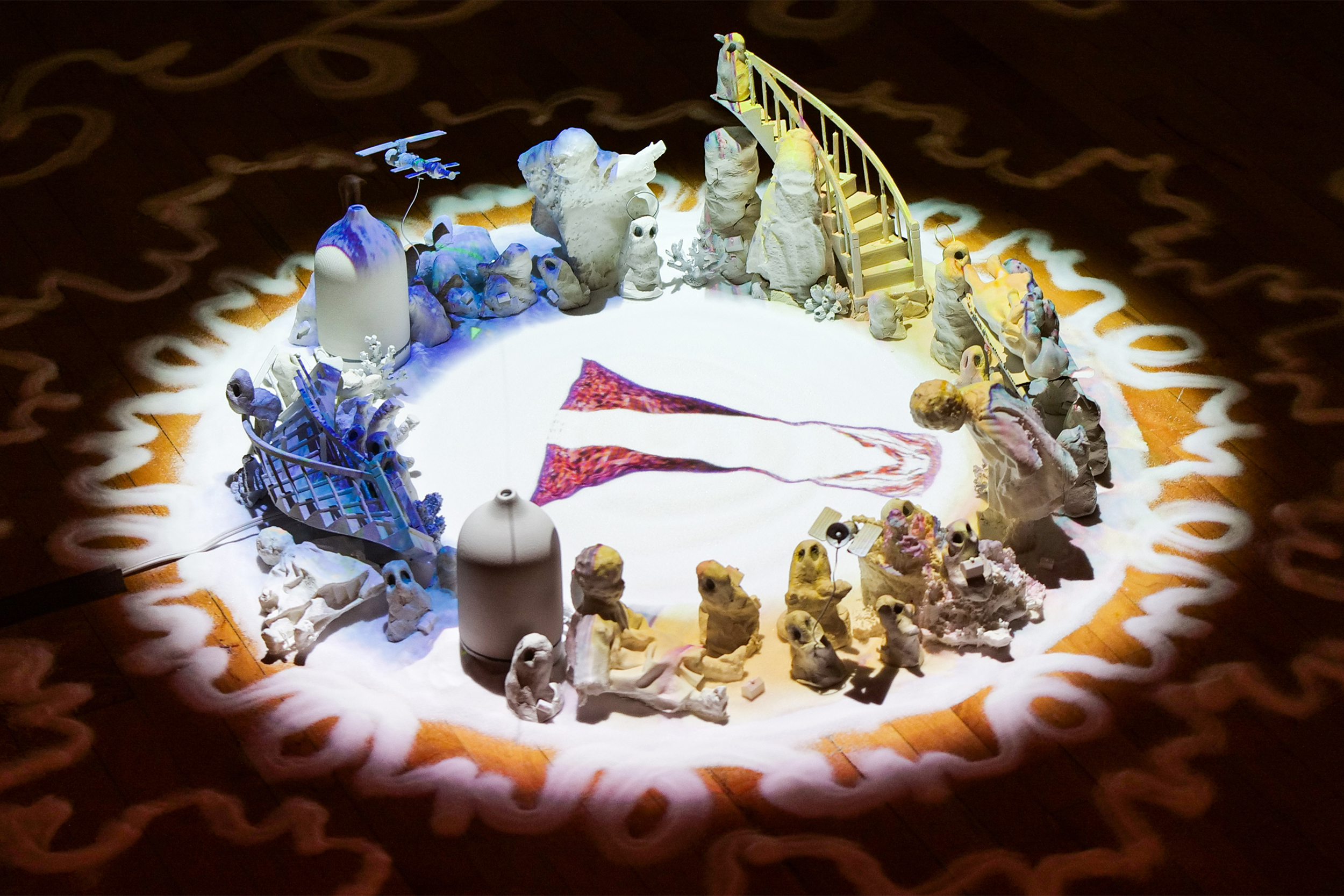 circle of small clay characters