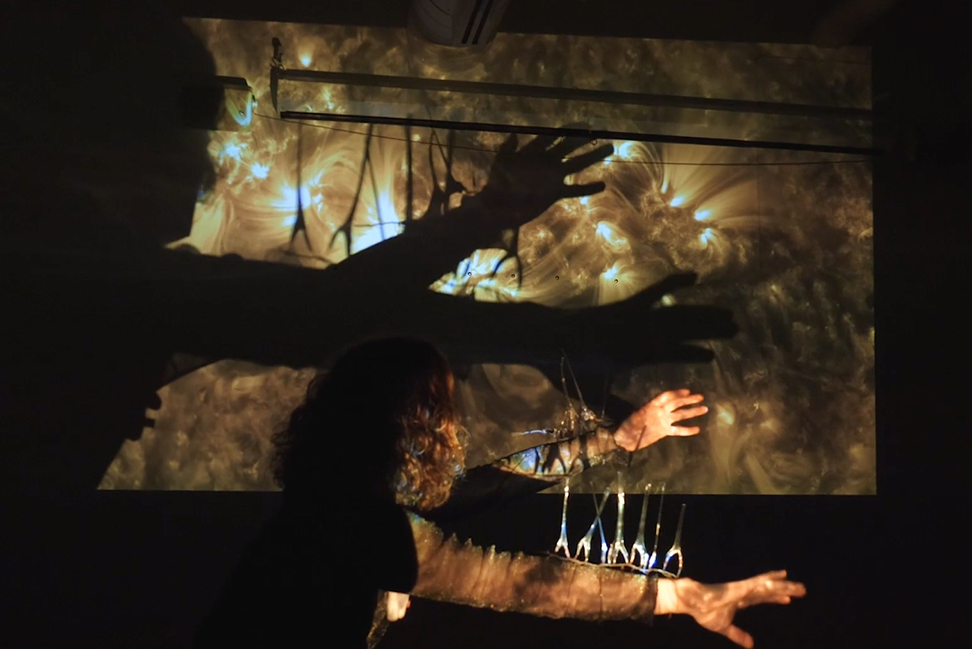 silhouette of a figure in front of projected image
