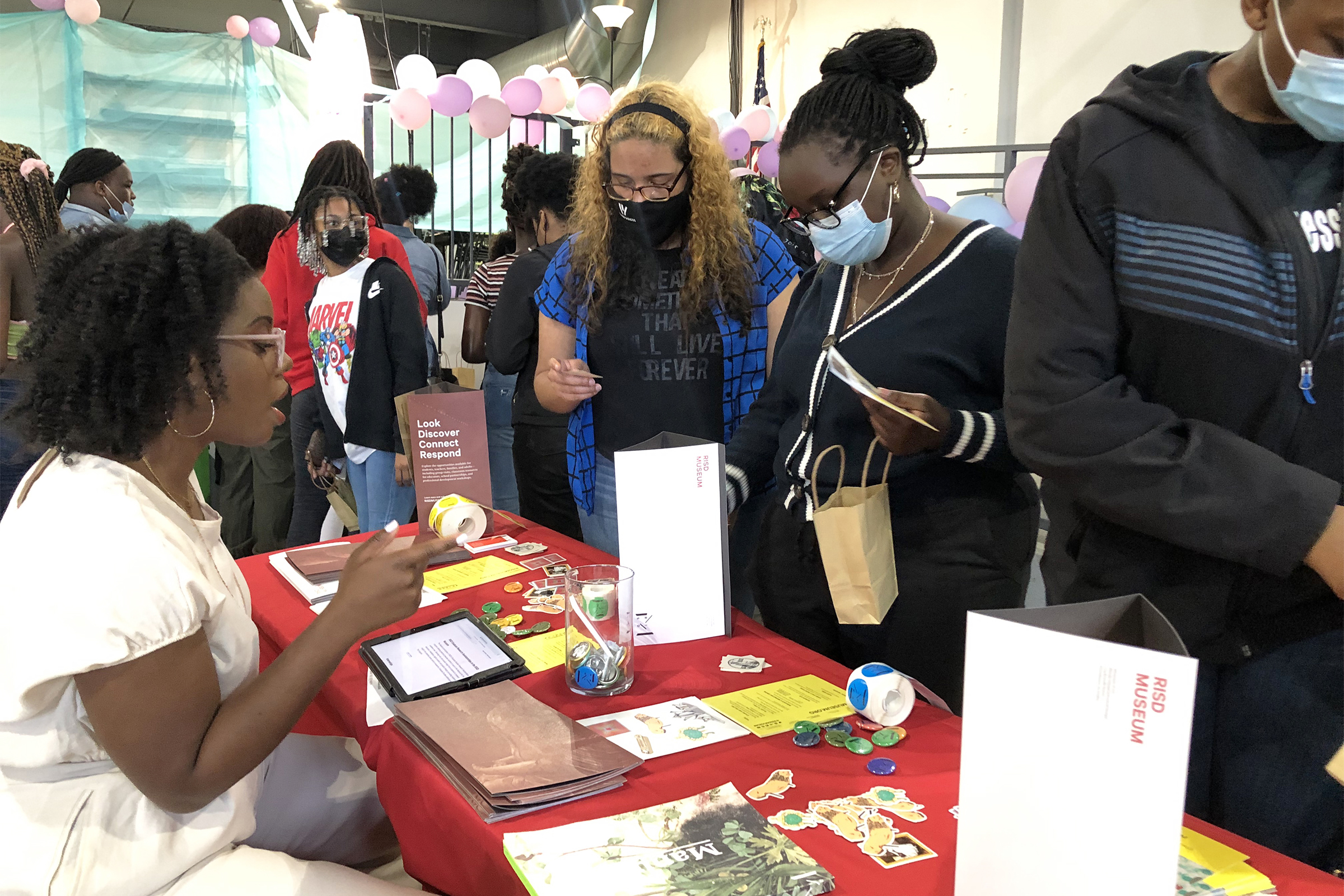 SEI programs specialist Kajette Solomon speaks with young museum visitors