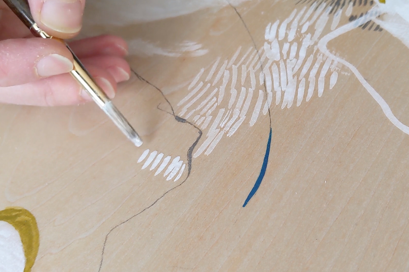 still image of a hand painting on paper