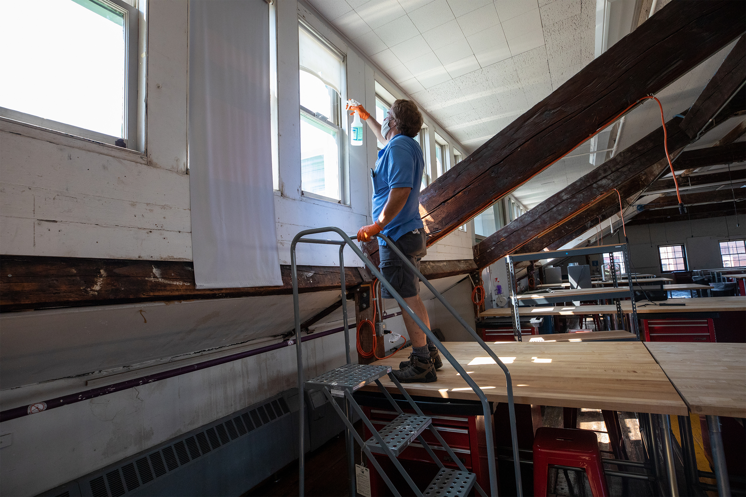 a worker cleans a window