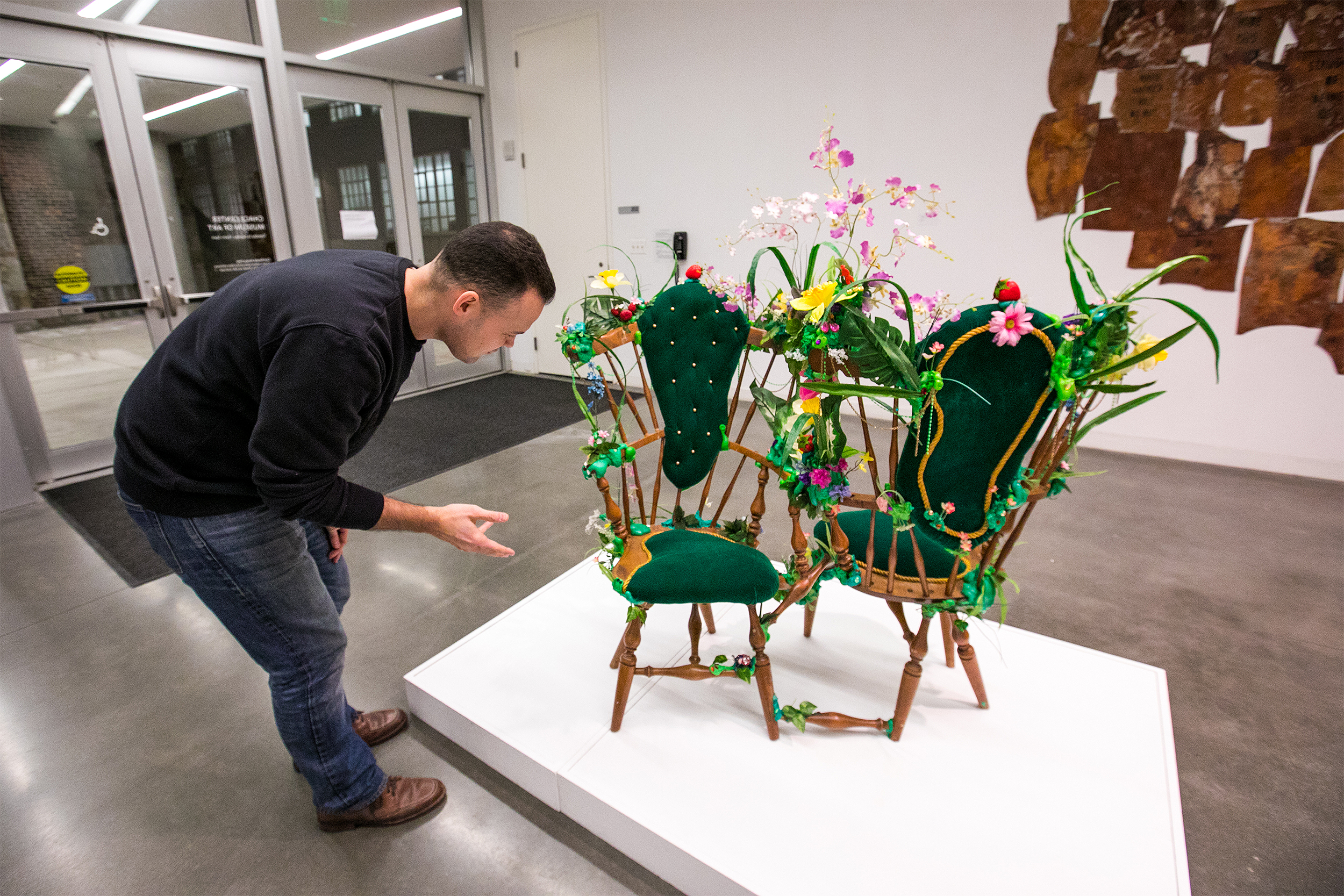 Kevin Hughes examines a piece on display