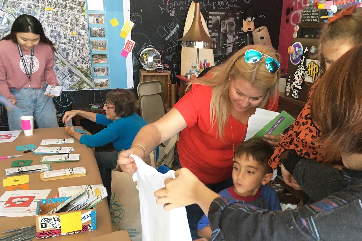 Students and community members working together on creative activities, like screenprinting