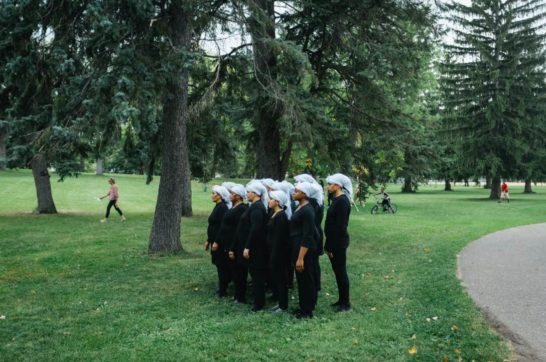 female dancers of all ages in white head scarves