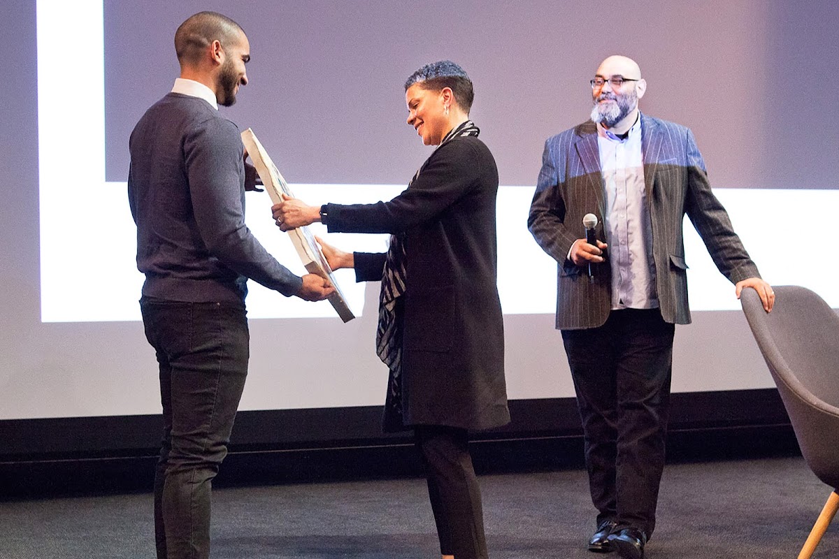 Activist Jordan Seaberry 14 PT with social justice visionary Michelle Alexander and Associate Provost Matthew Shenoda on stage
