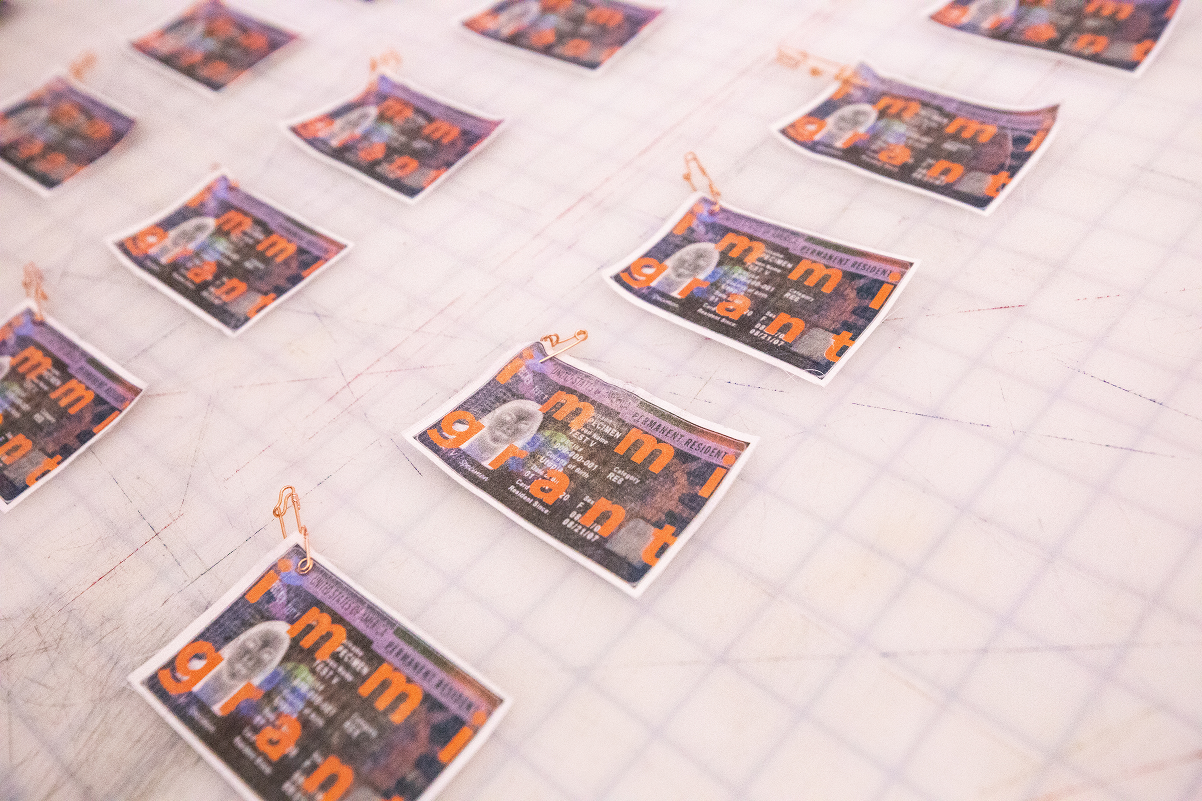 immigrant badges laid out on a table