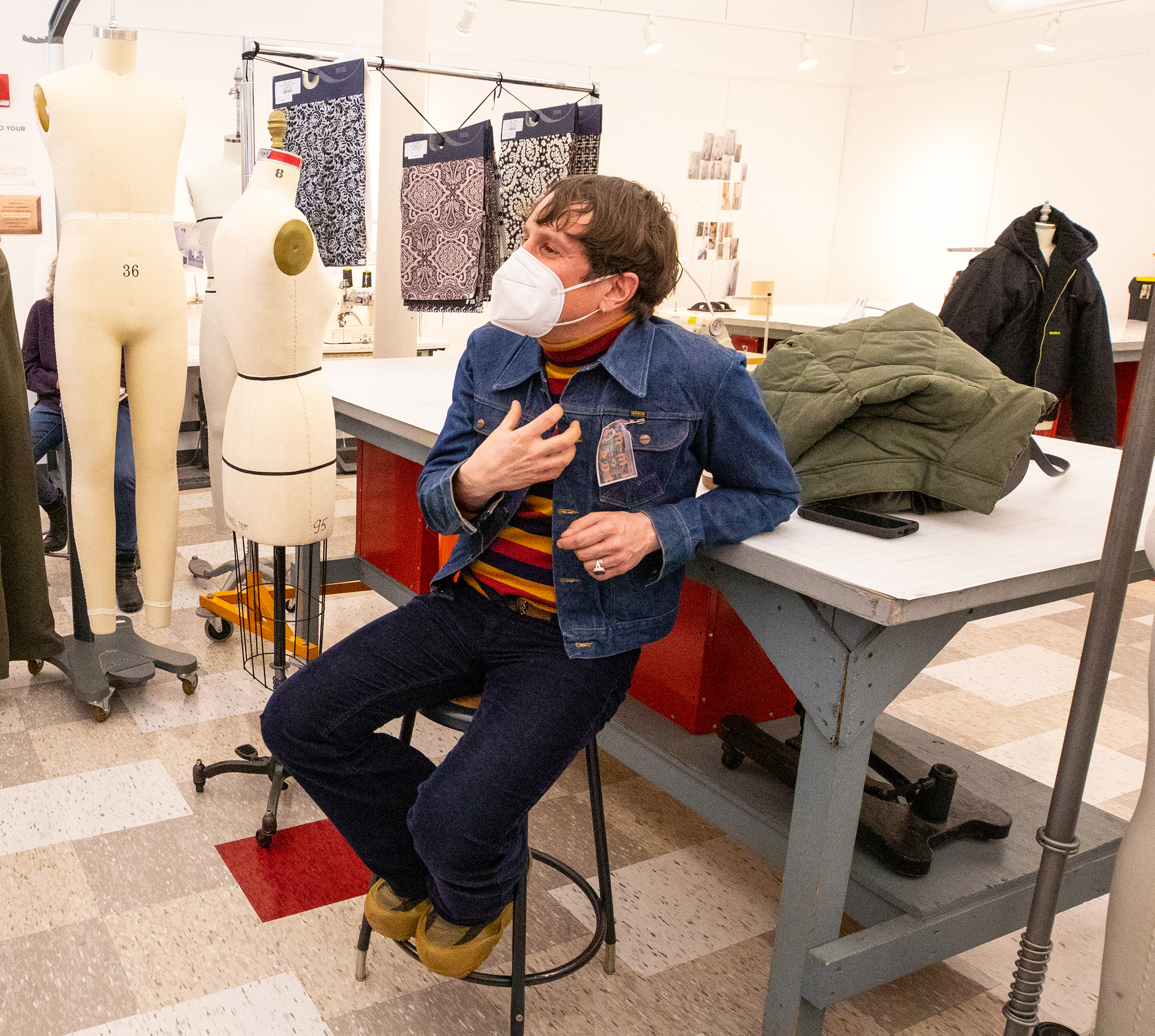 the professor addresses the class in the apparel design studio