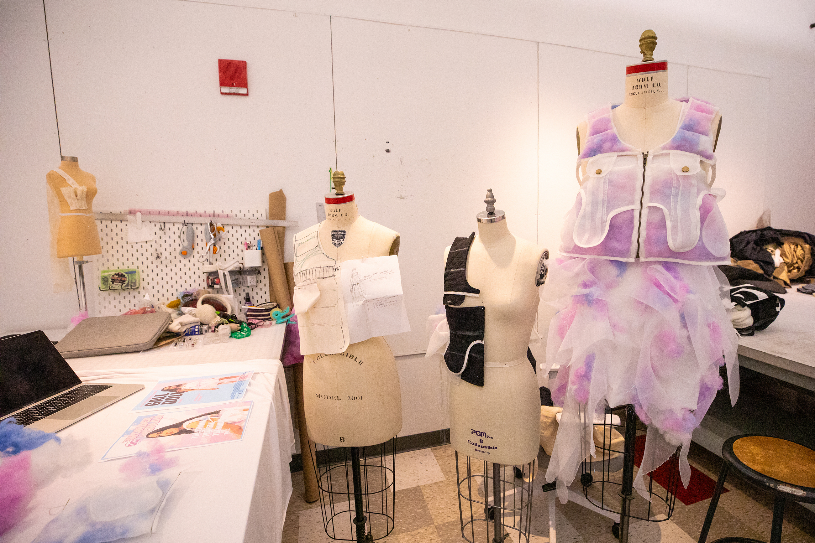a utility vest featuring fluffy pink and lavender accoutrements