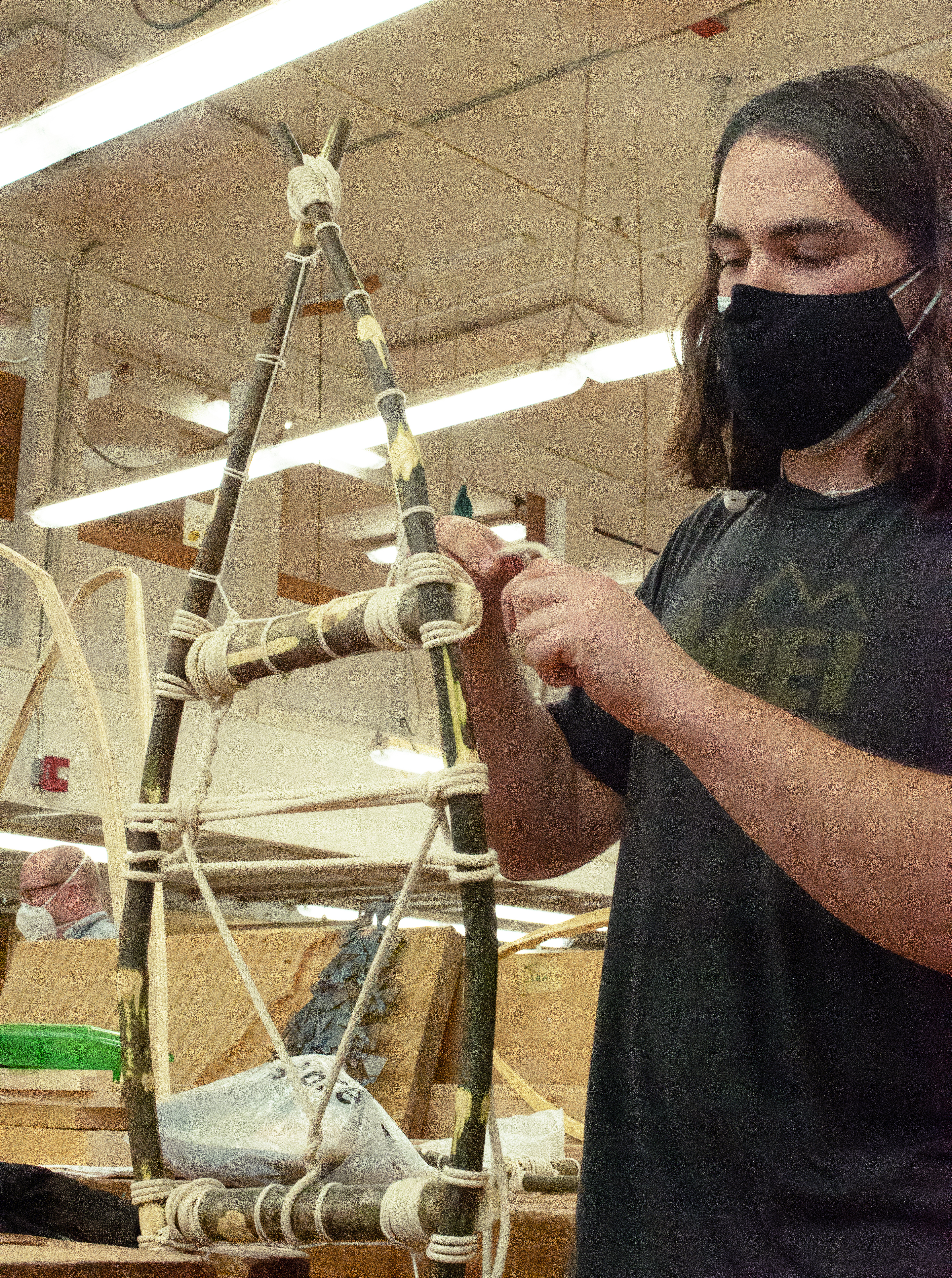 Jan Rybcznski works on a paper of Indigenous-designed snow shoes