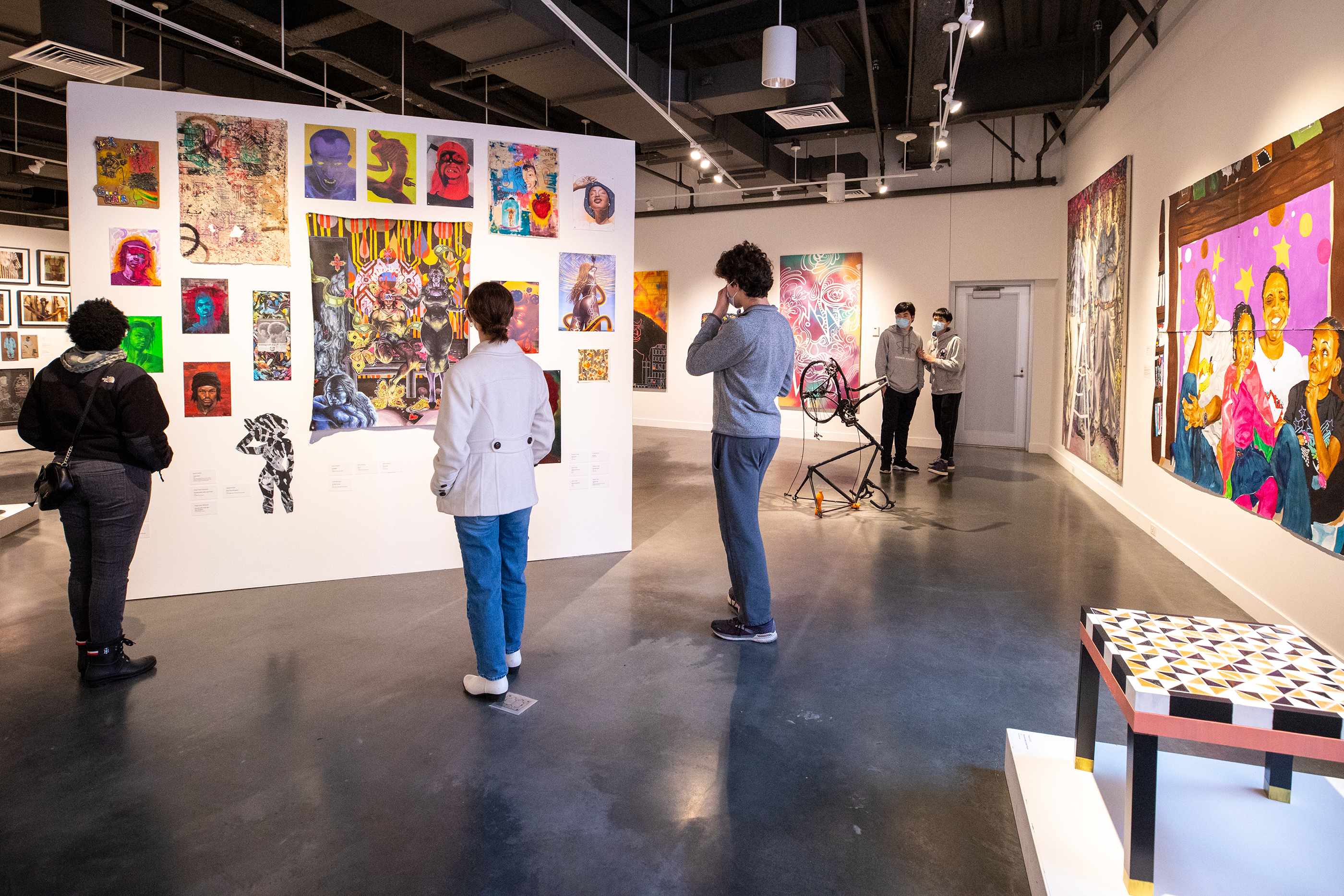 another view of the gallery with visitors admiring work