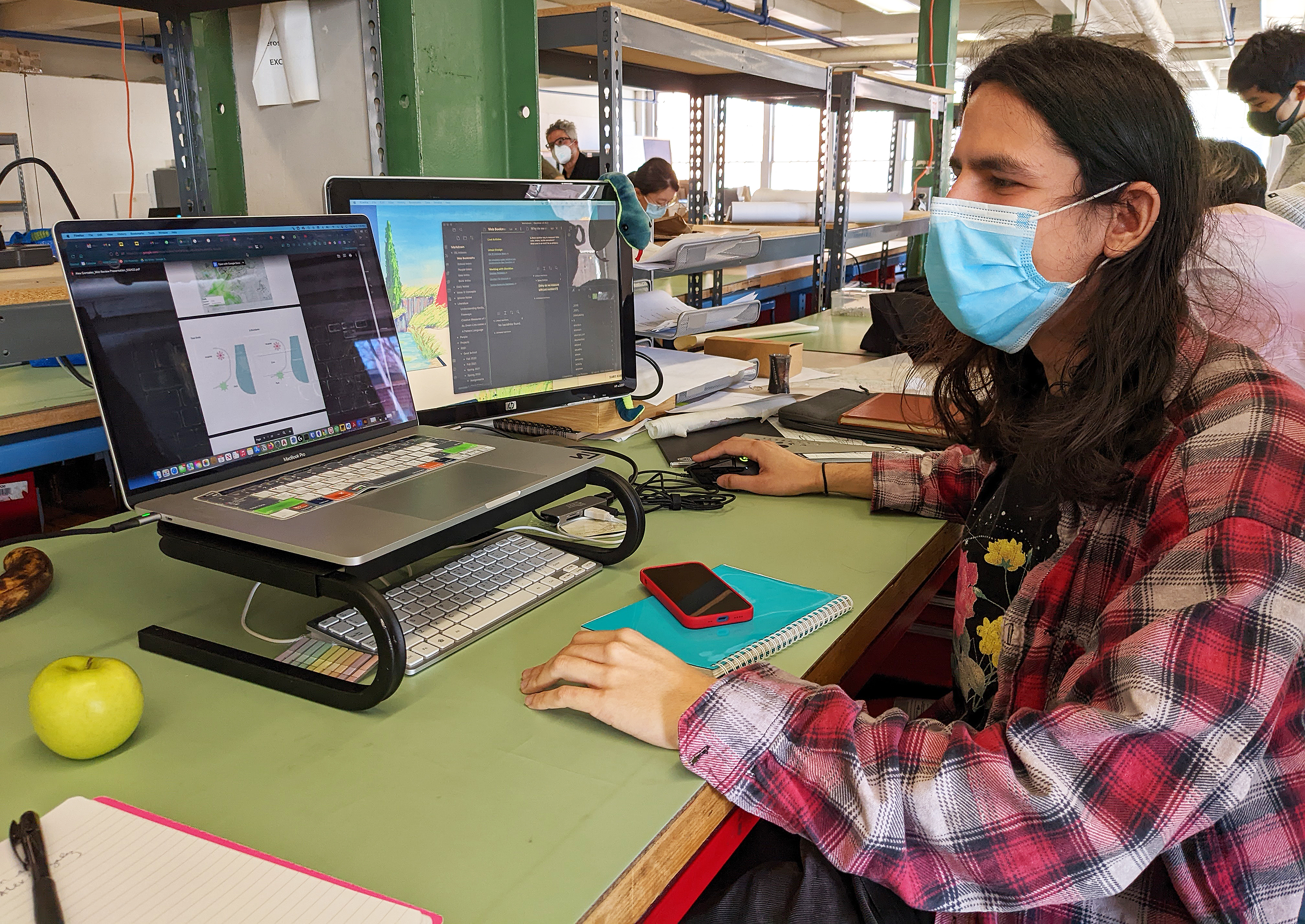graduate student Alex Gonzalez designs on his laptop