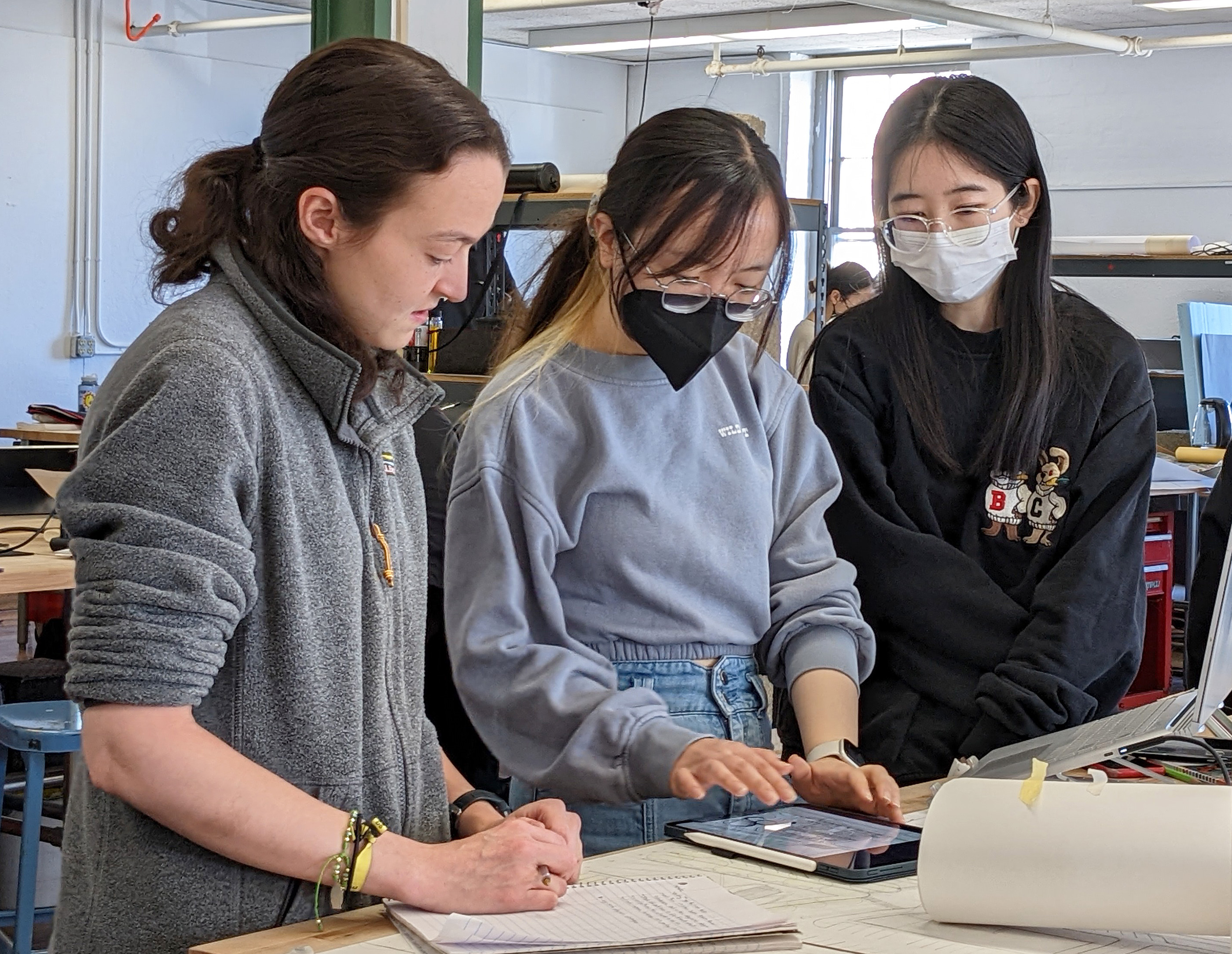 three students collaborate on mixed-use design plans