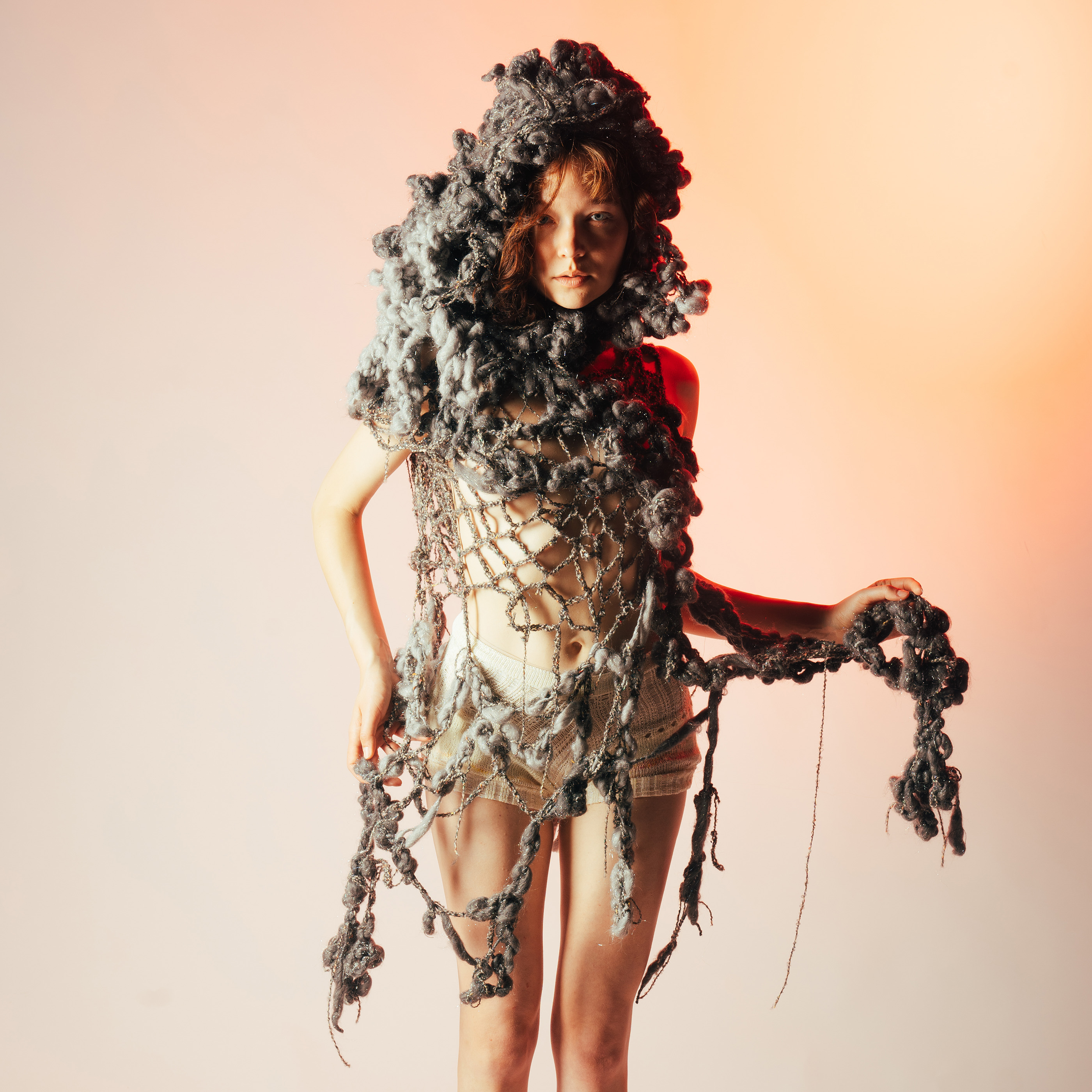 Model wearing knitted garment