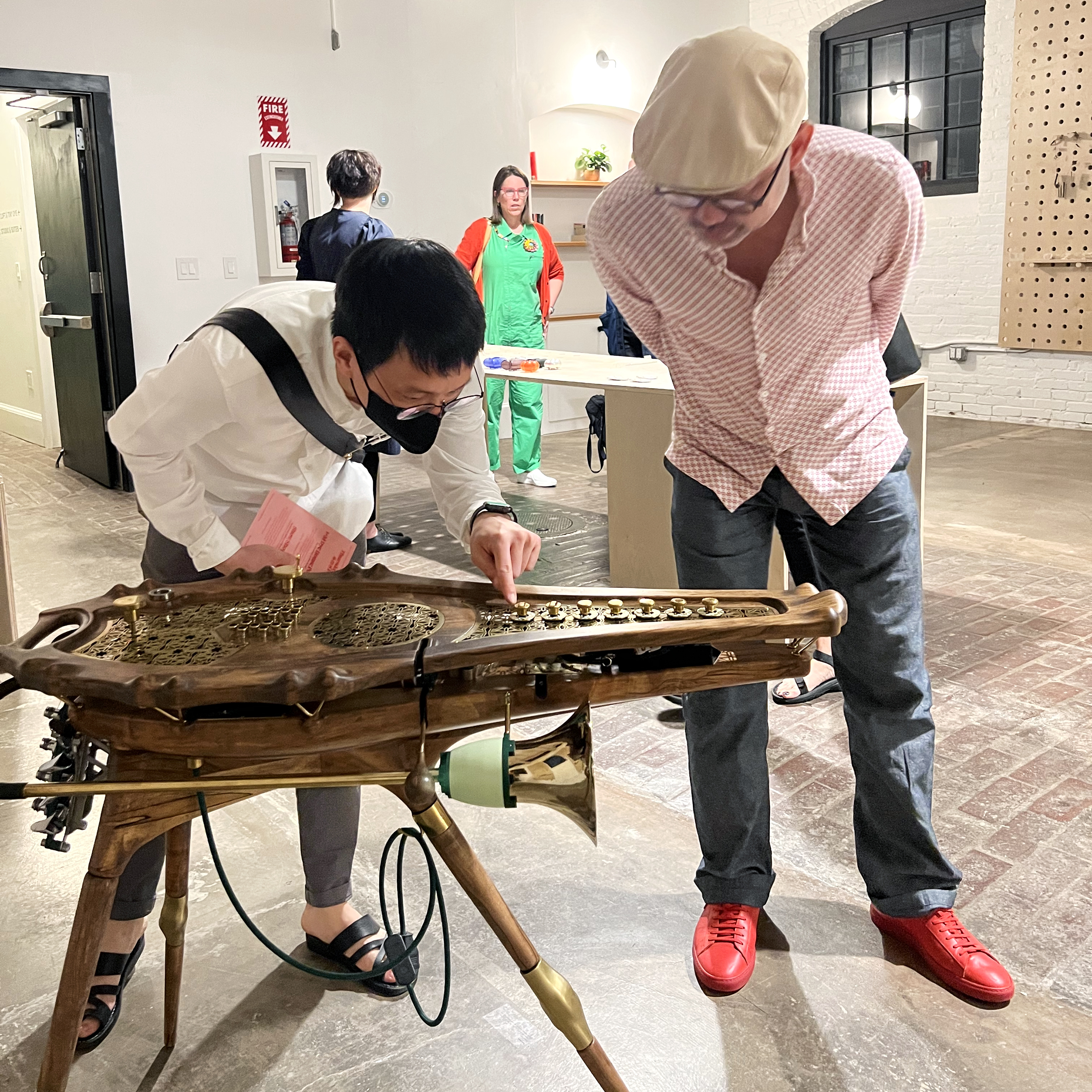 SNAG attendees view a large wooden instrument