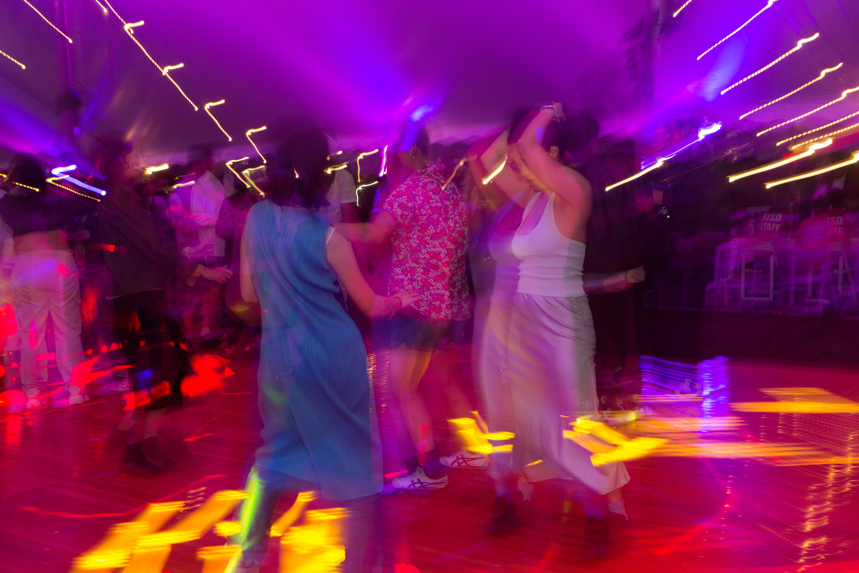 a swirl of dancers under the lights