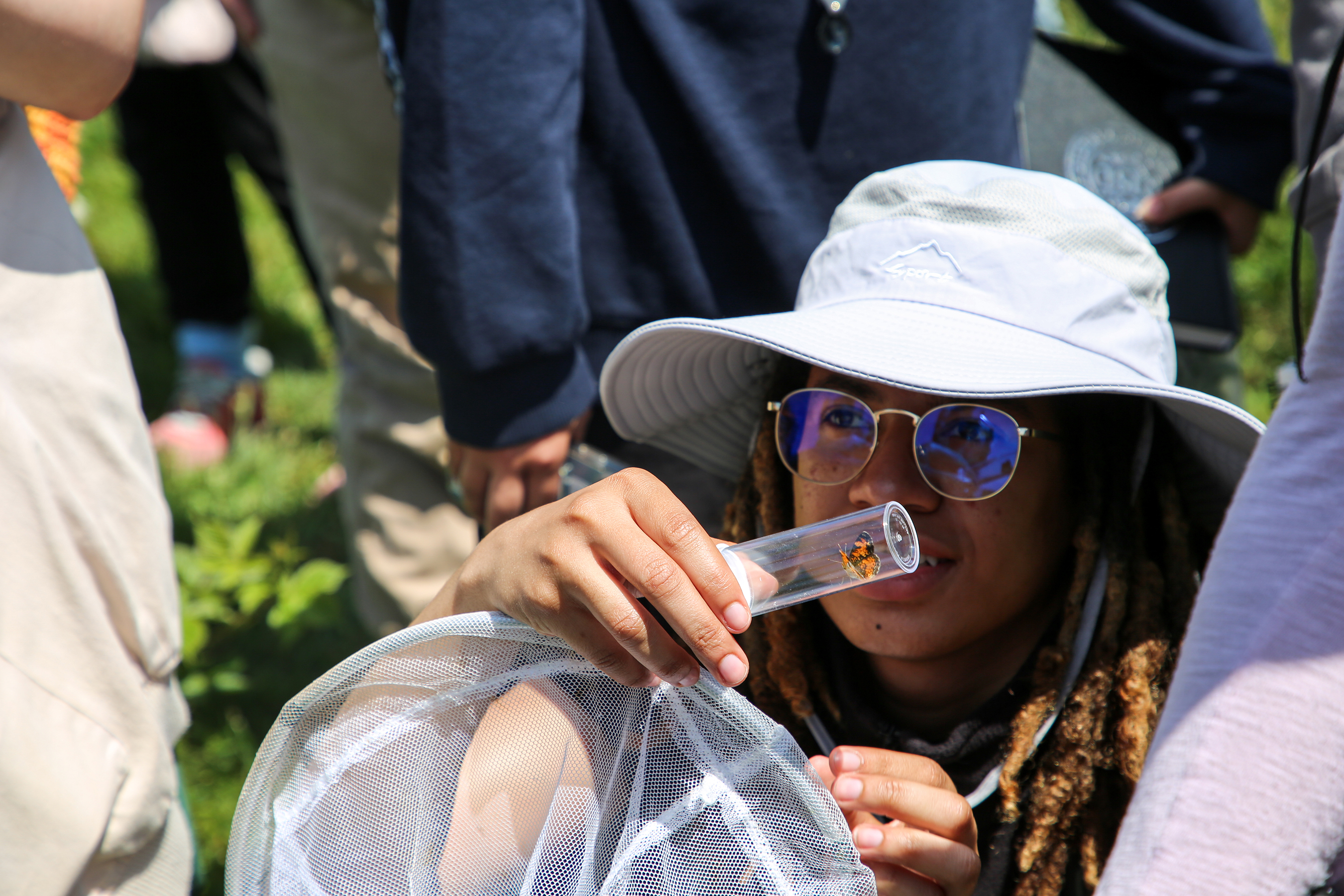 Naomi Canino MLA 24 catches a pearl crescent butterfly.