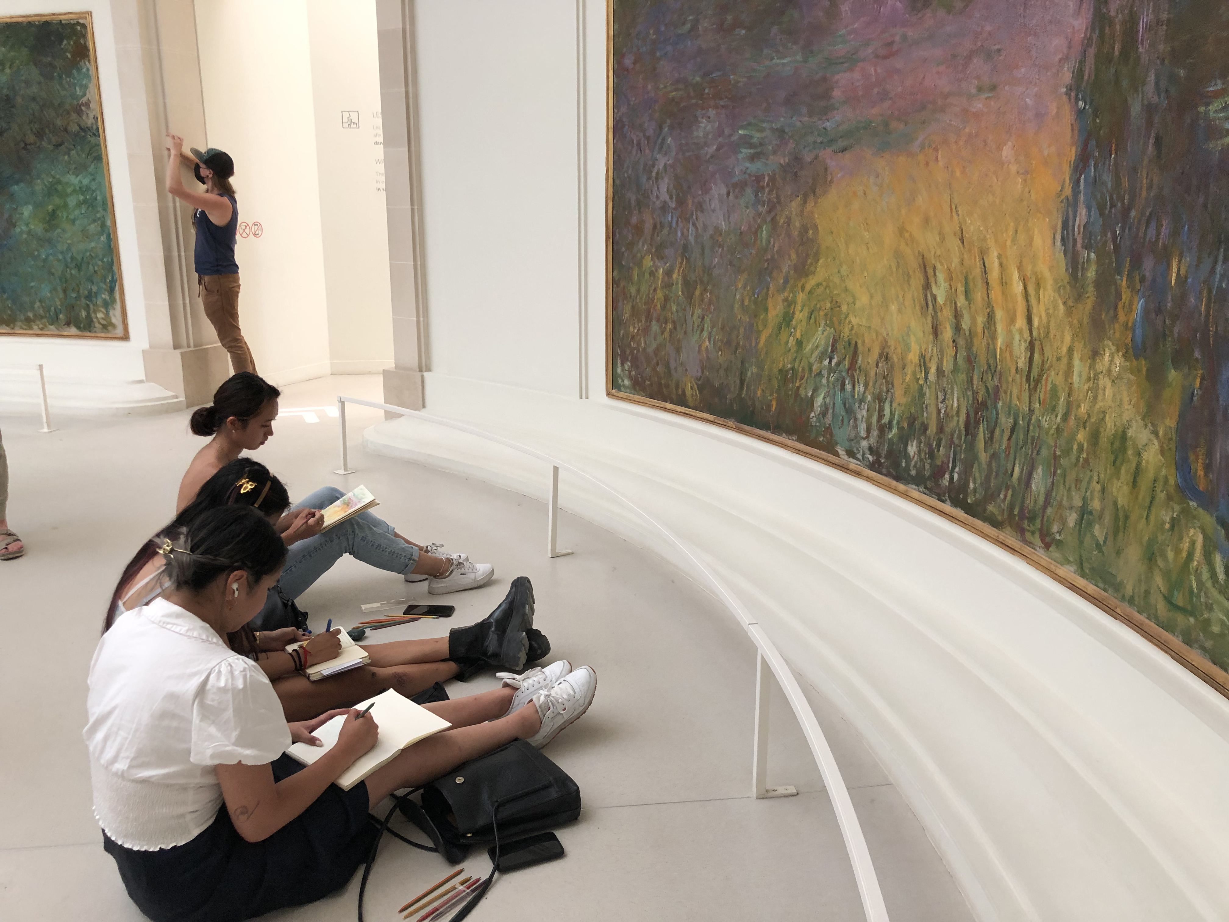 students sketching in a museum
