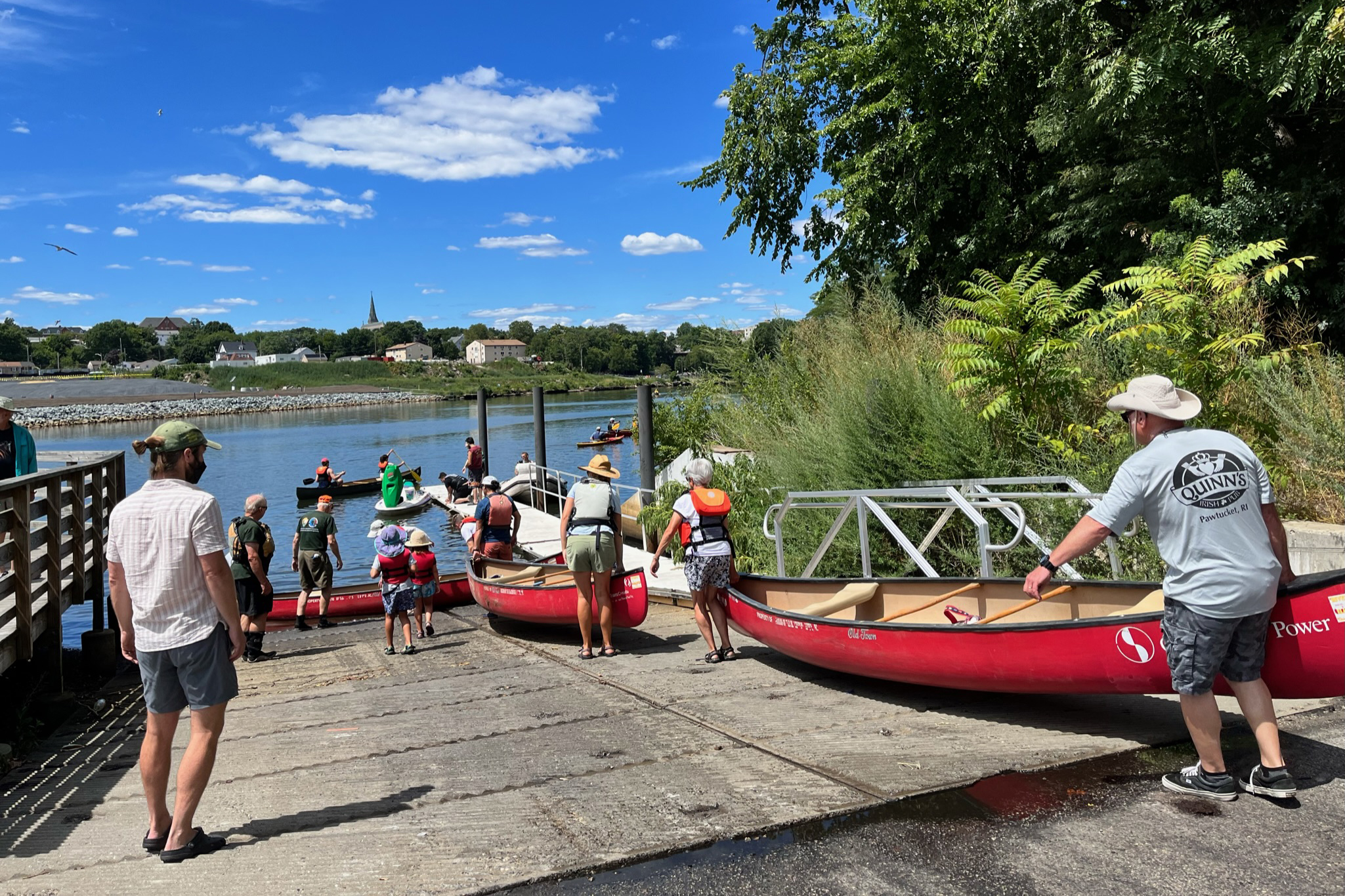 Paddlers take off from a local boat launch down the Blackstone River