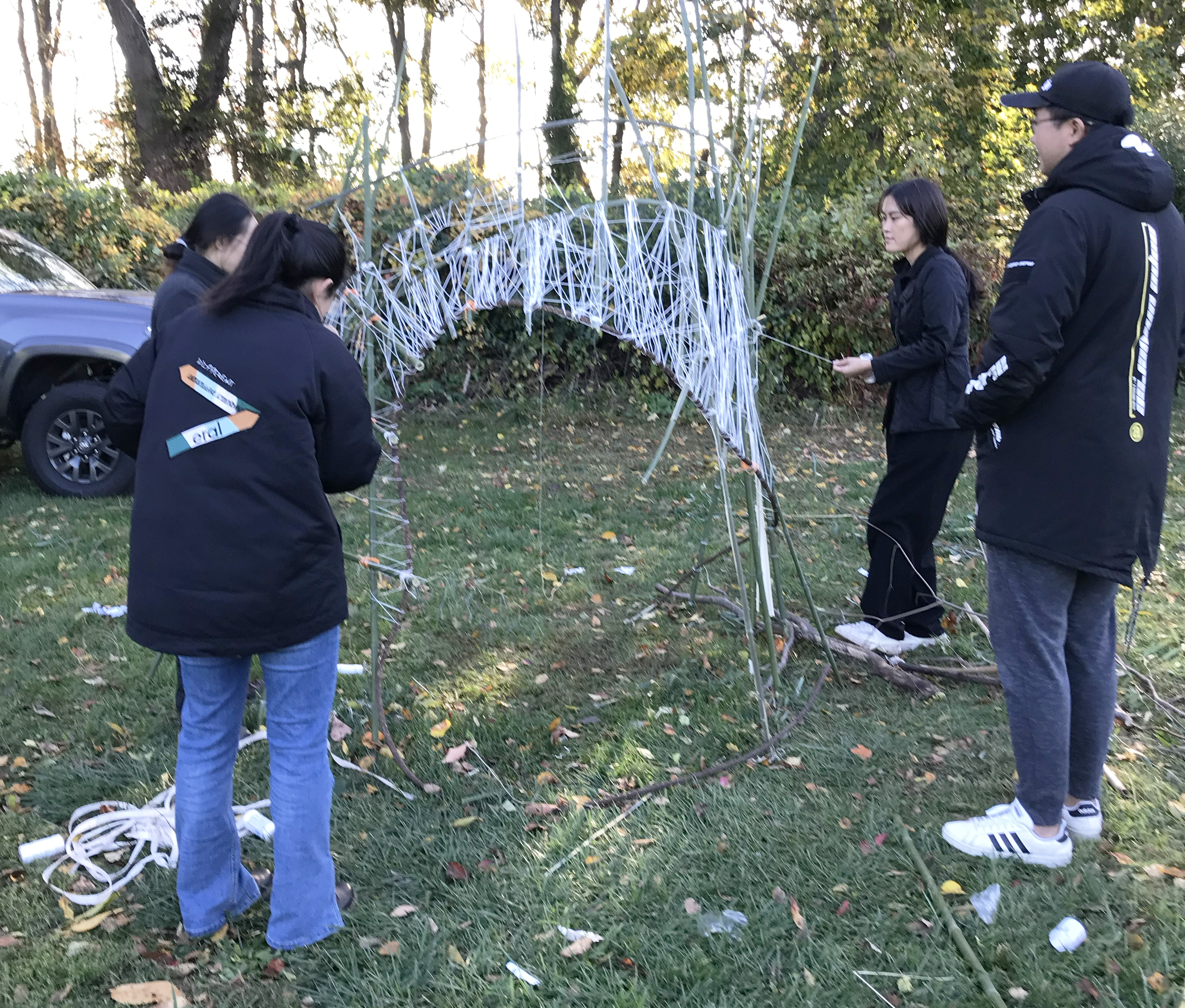 students weave an object for installation