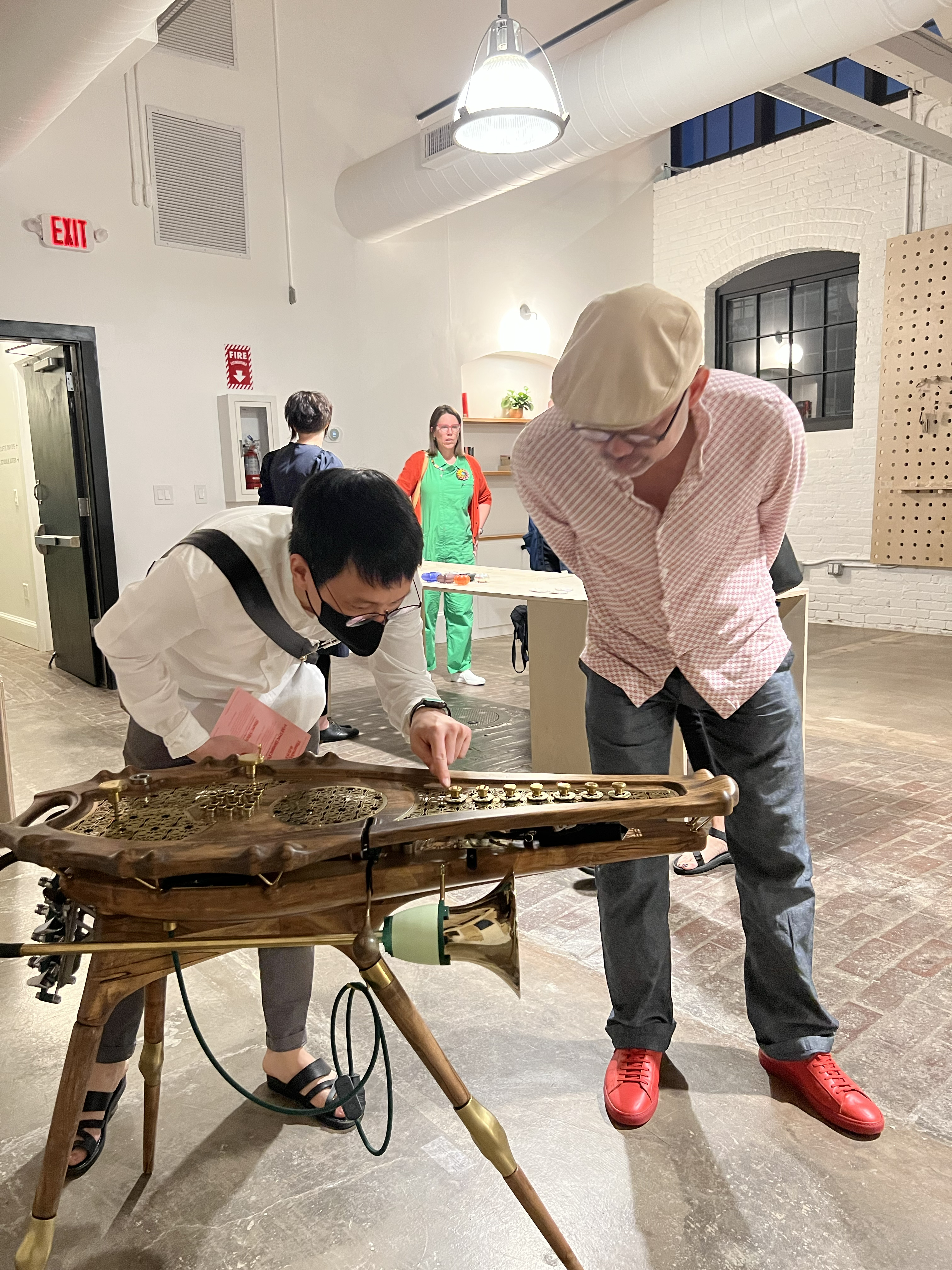 conference participants examine work on display