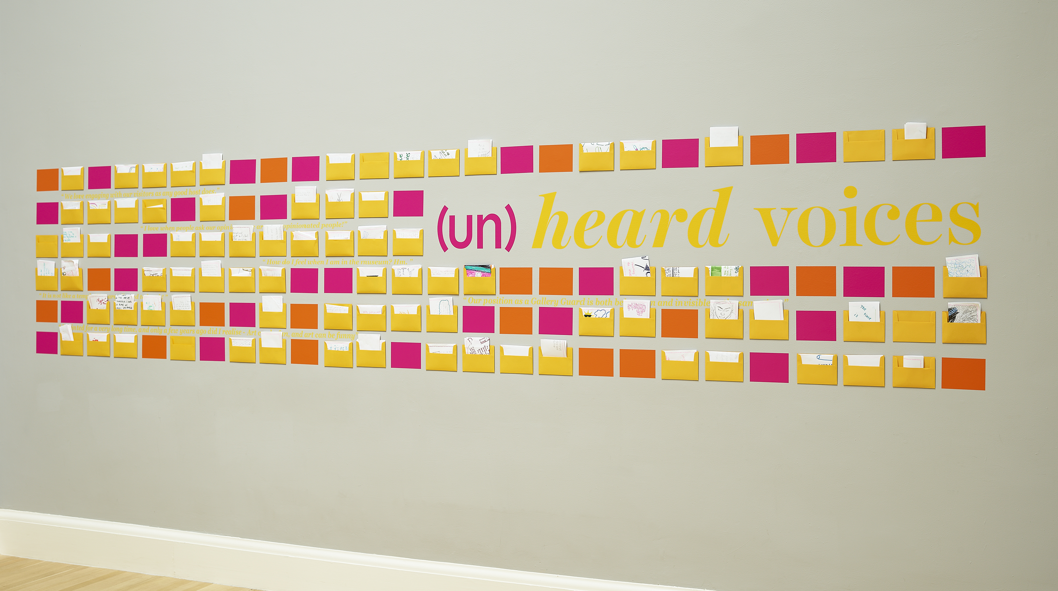 yellow and red (un)heard voices installation on the wall