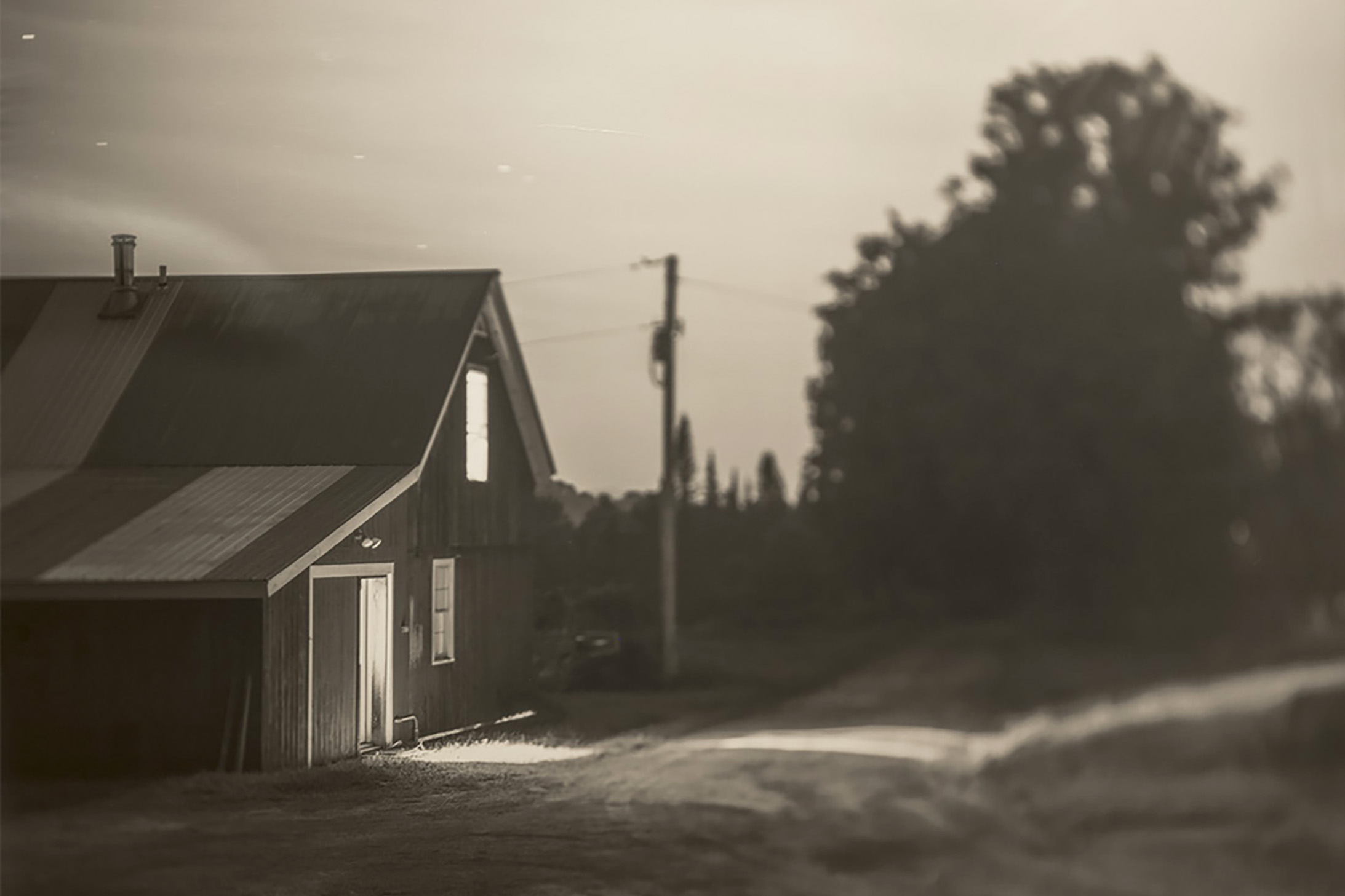 sepia-toned image of a barn at dusk by Ethan Brossard