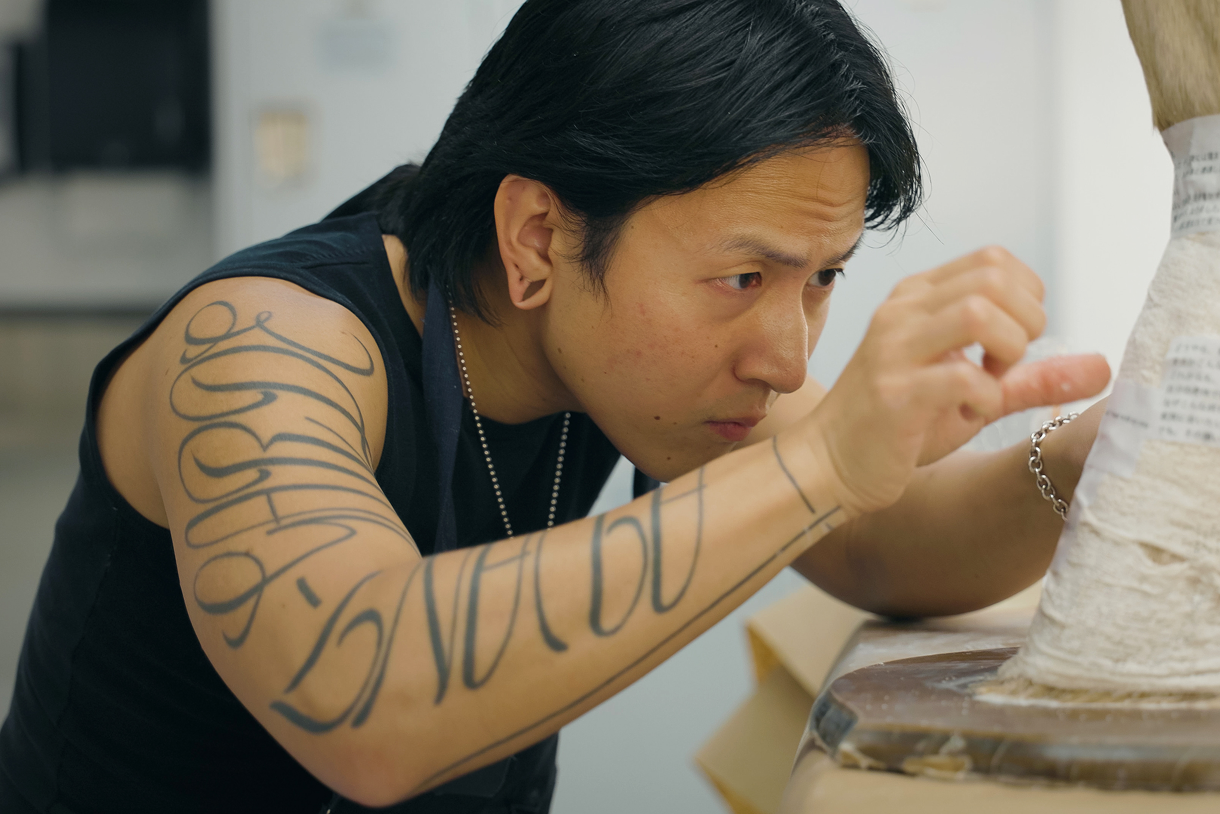 an adult learner works intensely during CE Sculptural Design class