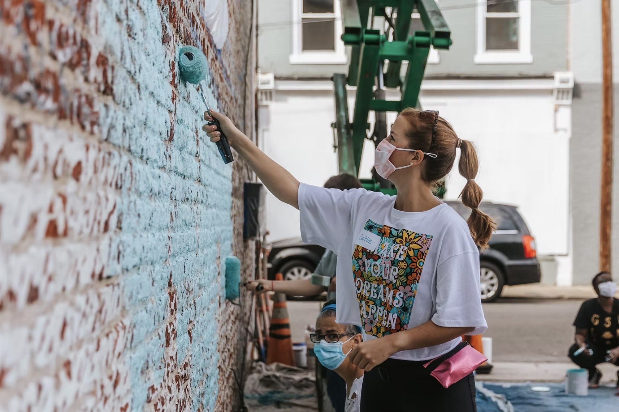 Assistant Professor Caitlin Blank Preps a brick wall for a mural