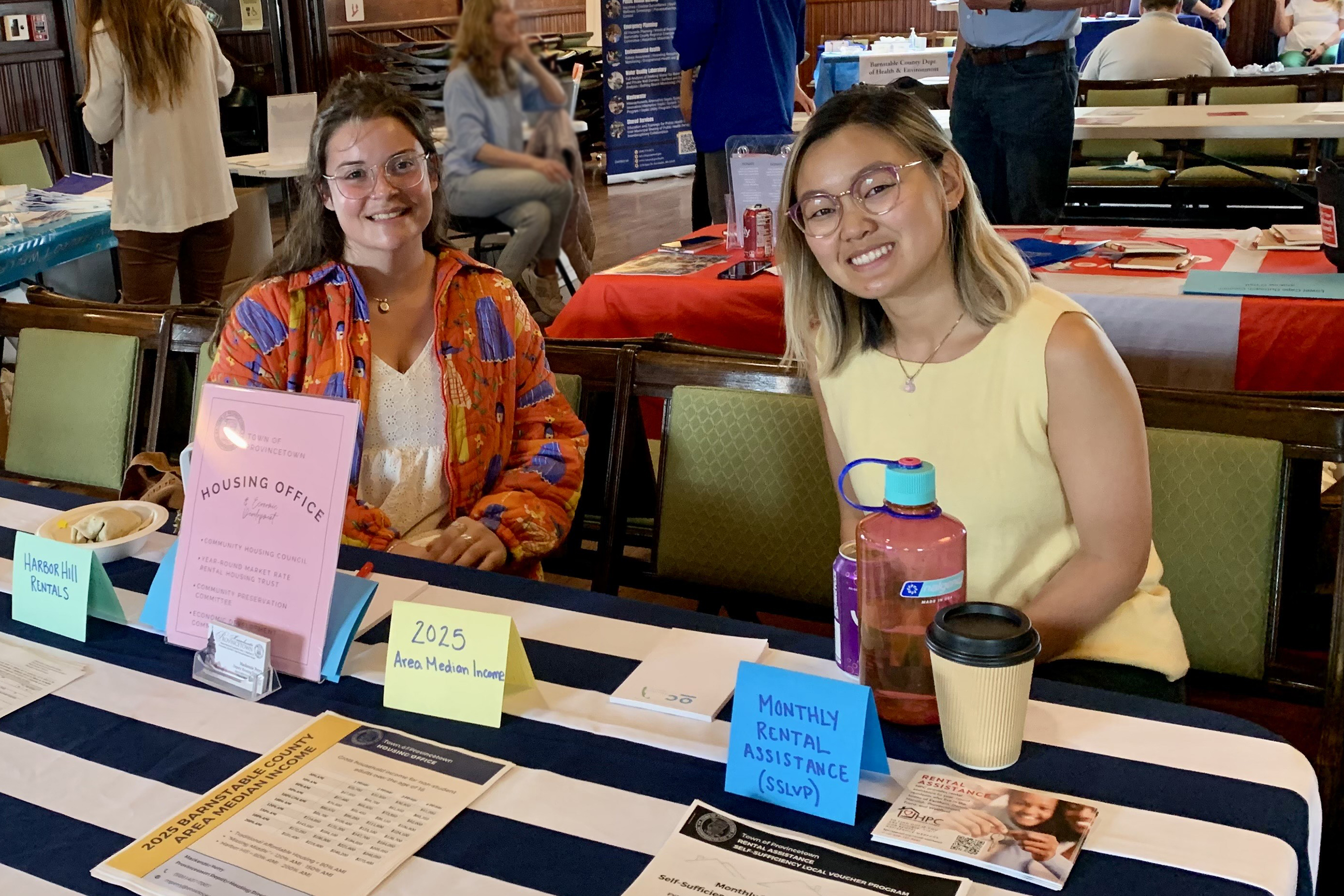 Kylee Hong staffs an information table for the Provincetown Housing Office and Community Development Department