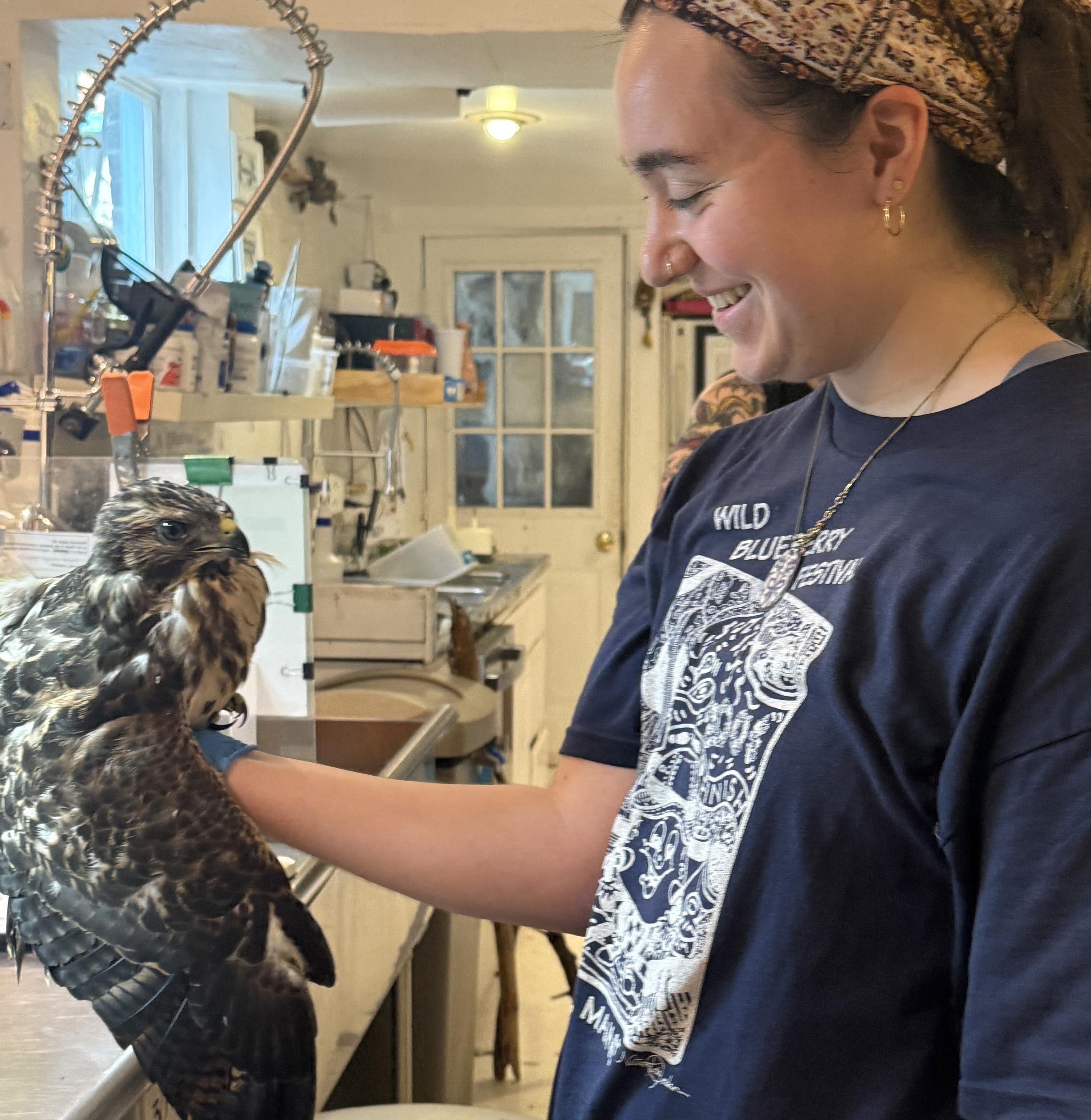 Sofia Schreiber handles a hawk at Congress of the Birds