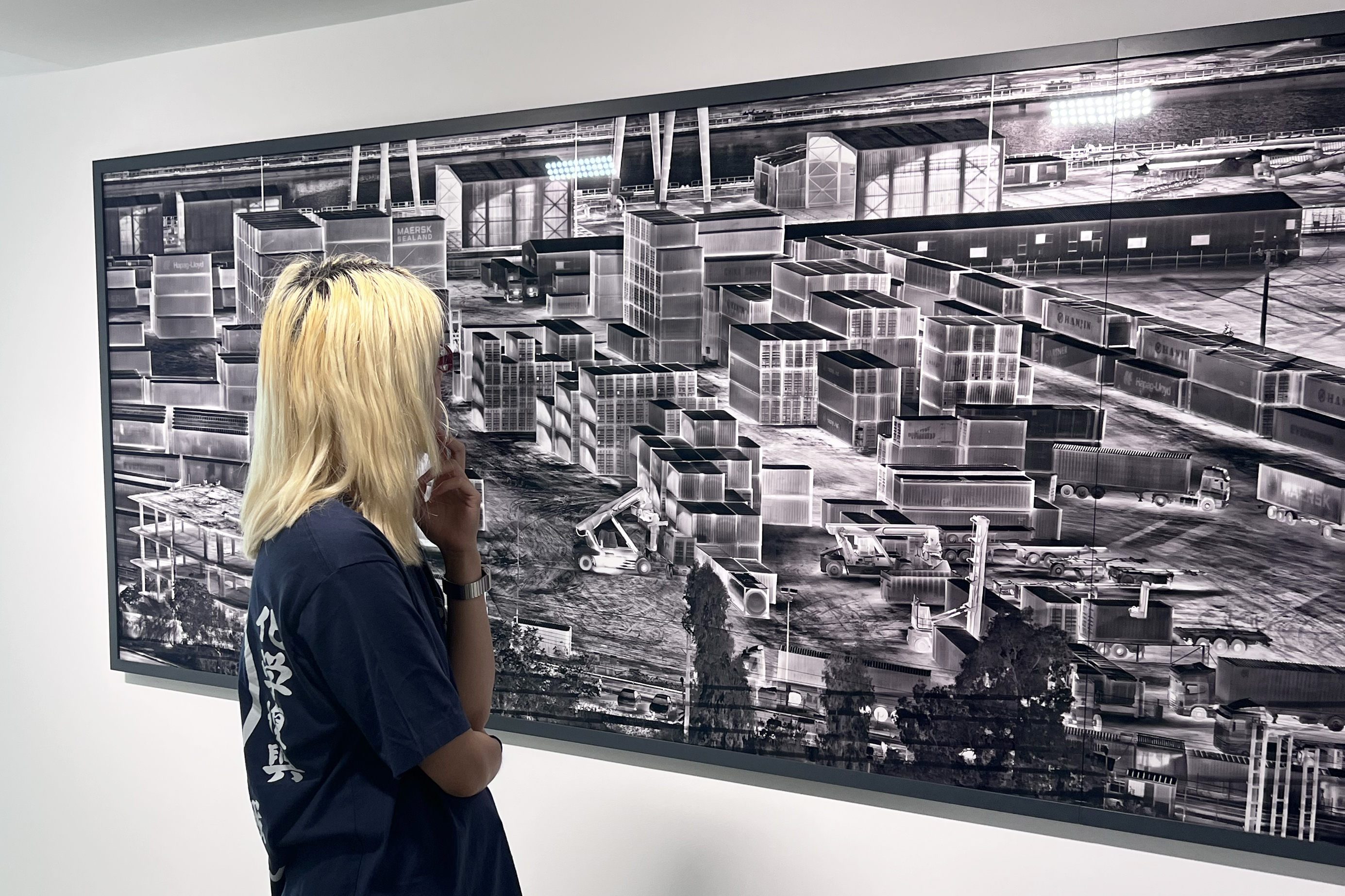 student on Trek 2025 examines a black-and-white rendering
