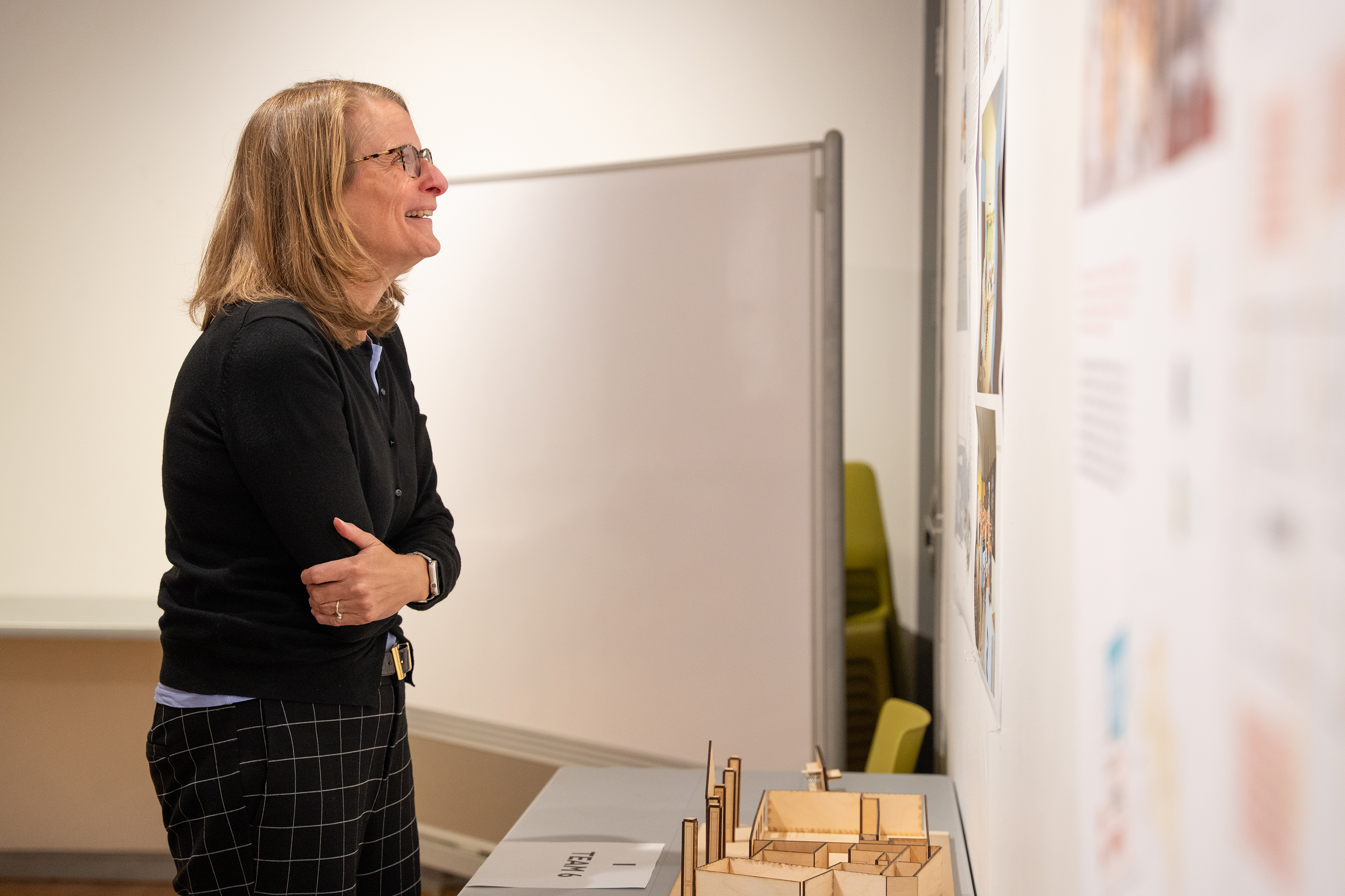 Erin Spaulding smiles as she examines the team proposals posted in the CIT