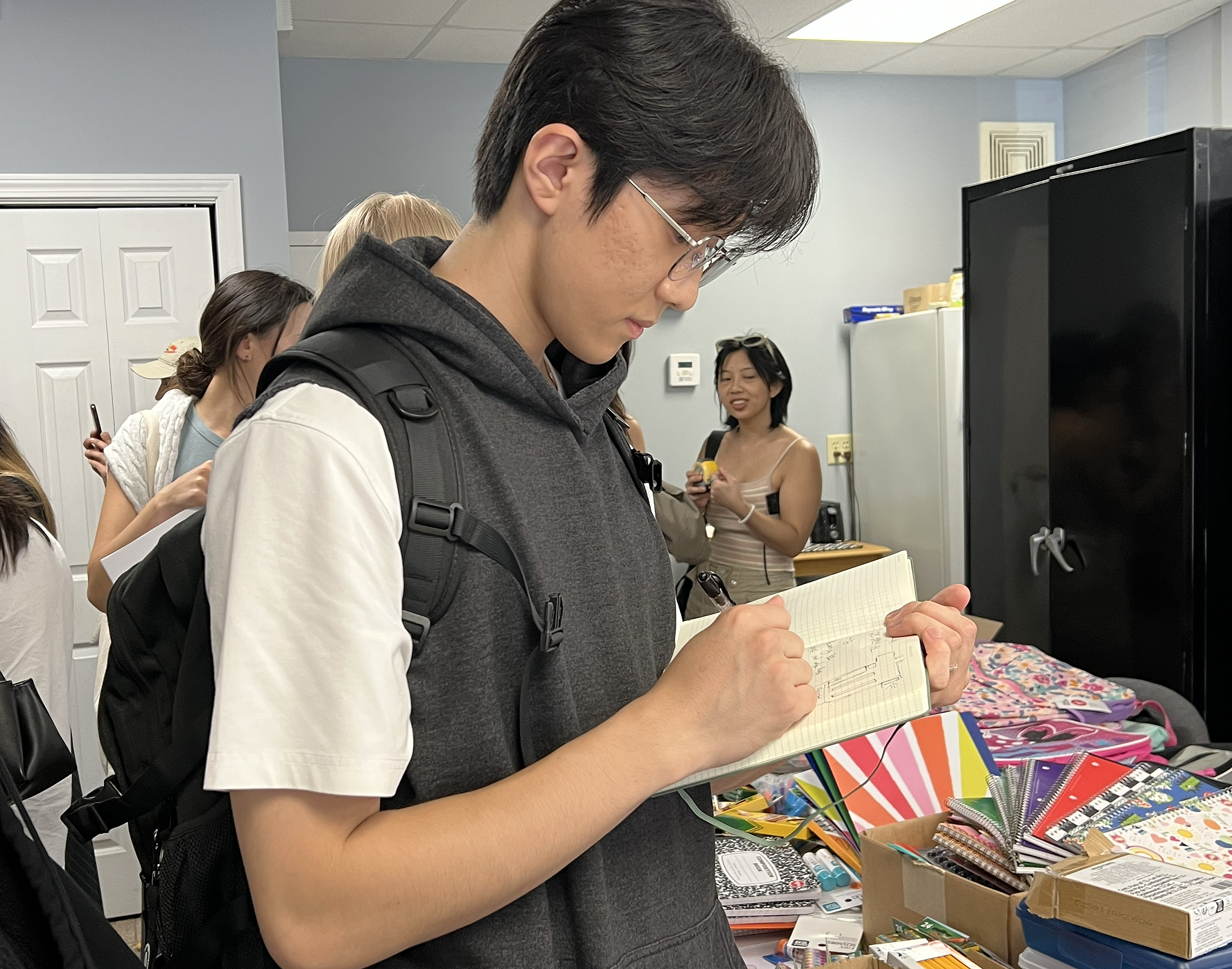 a student sketches the space during brief tour of the space