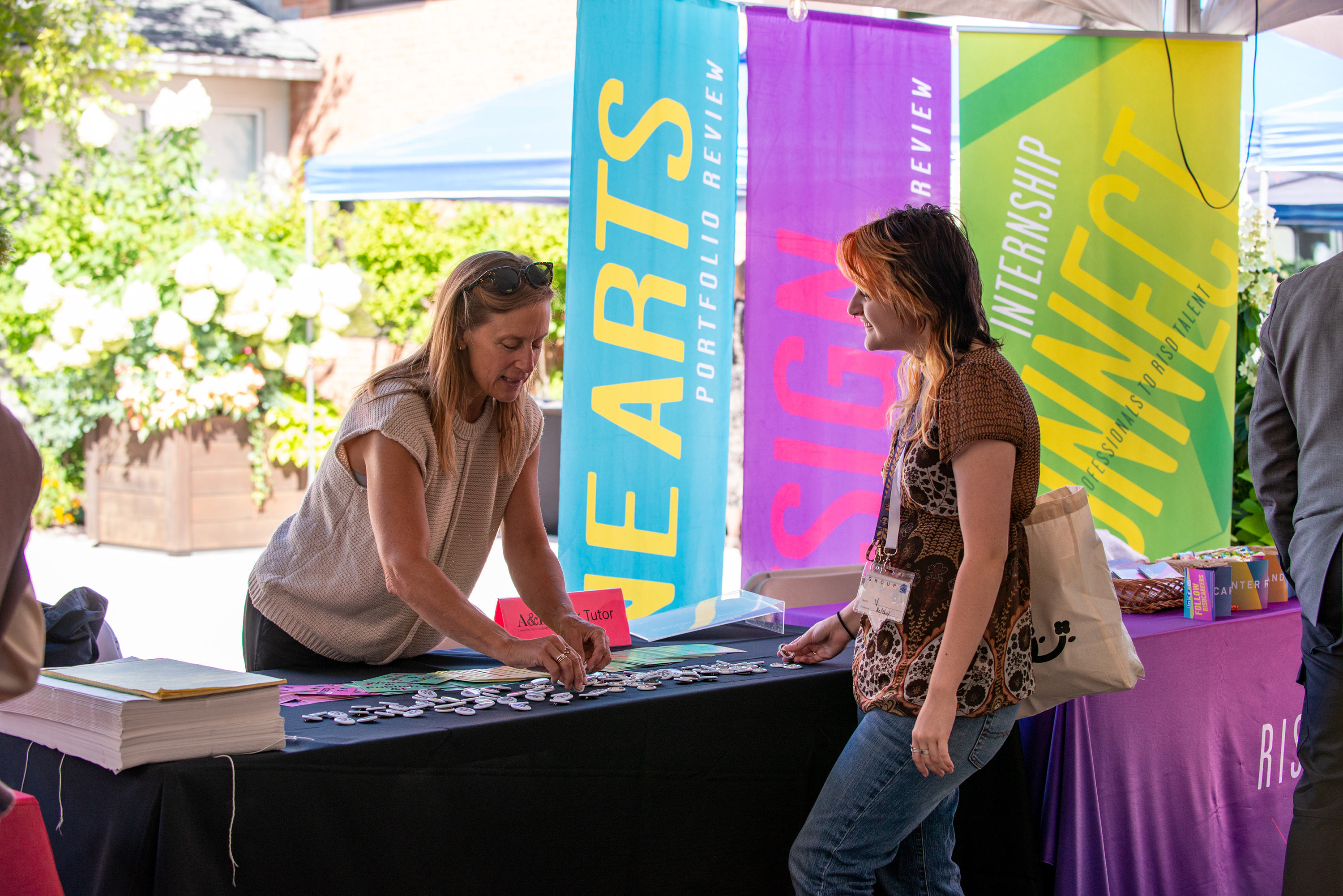 staff member Jen Liese staffs a student resources table at move-in 2025